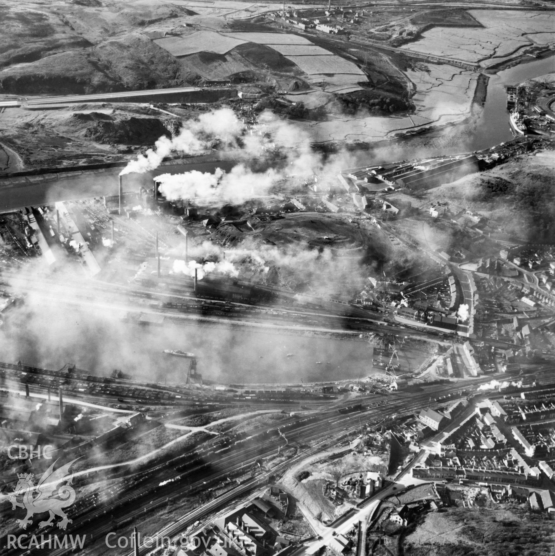View of Briton Ferry and the Cleveland Bridge under construction. Oblique aerial photograph, 5?" cut roll film.
