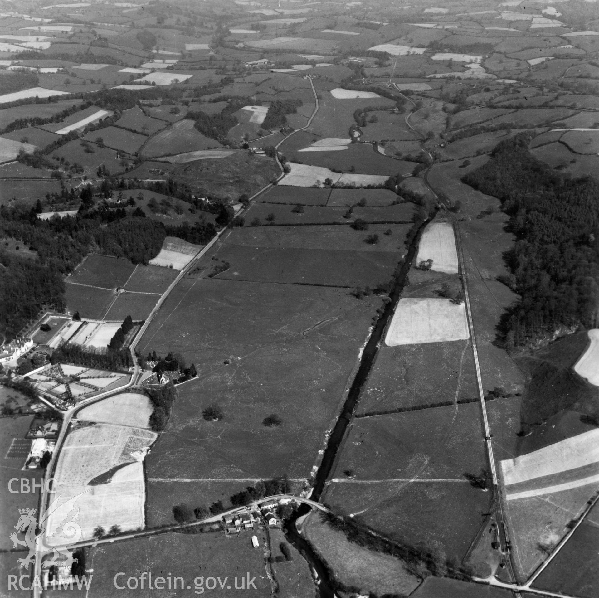 View of the Tanat valley showing railway, Llangedwyn Hall garden and Llangedwyn Bridge. Oblique aerial photograph.