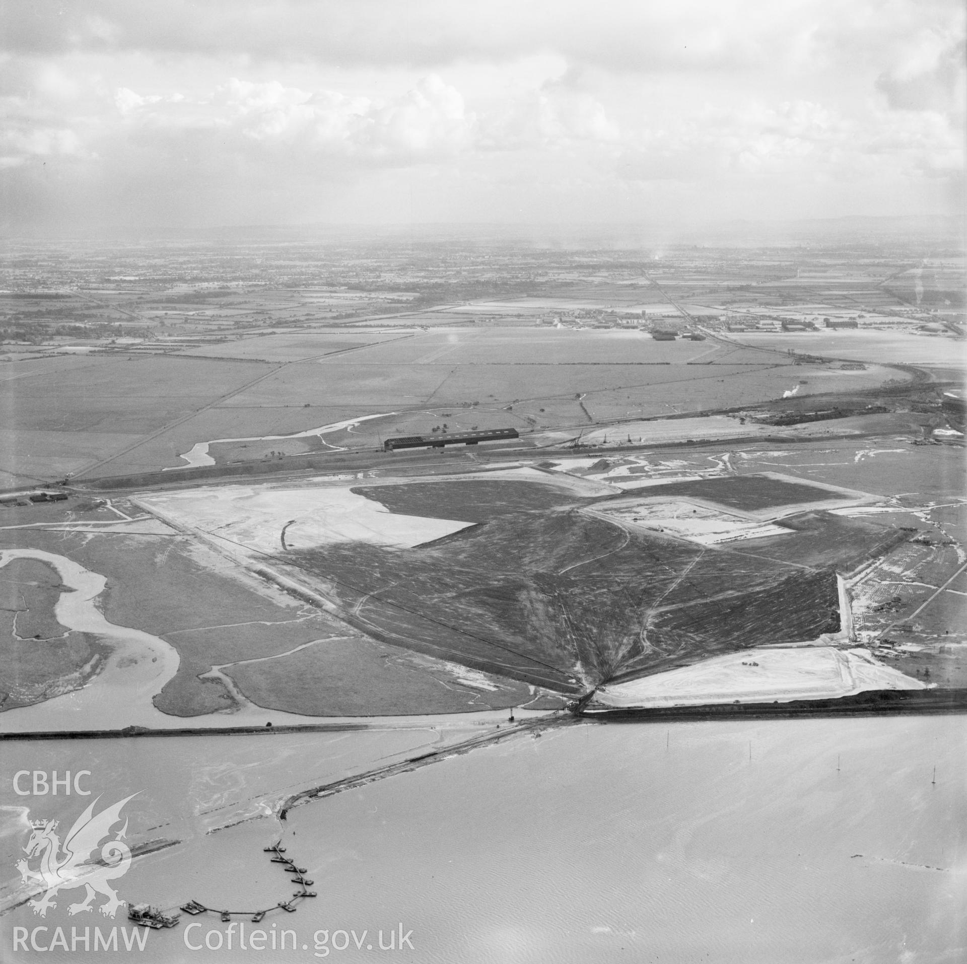 View of the dredging of the Shotton steelworks site (commissioned by Westminster Dredging Co.). Oblique aerial photograph, 5?" cut roll film.