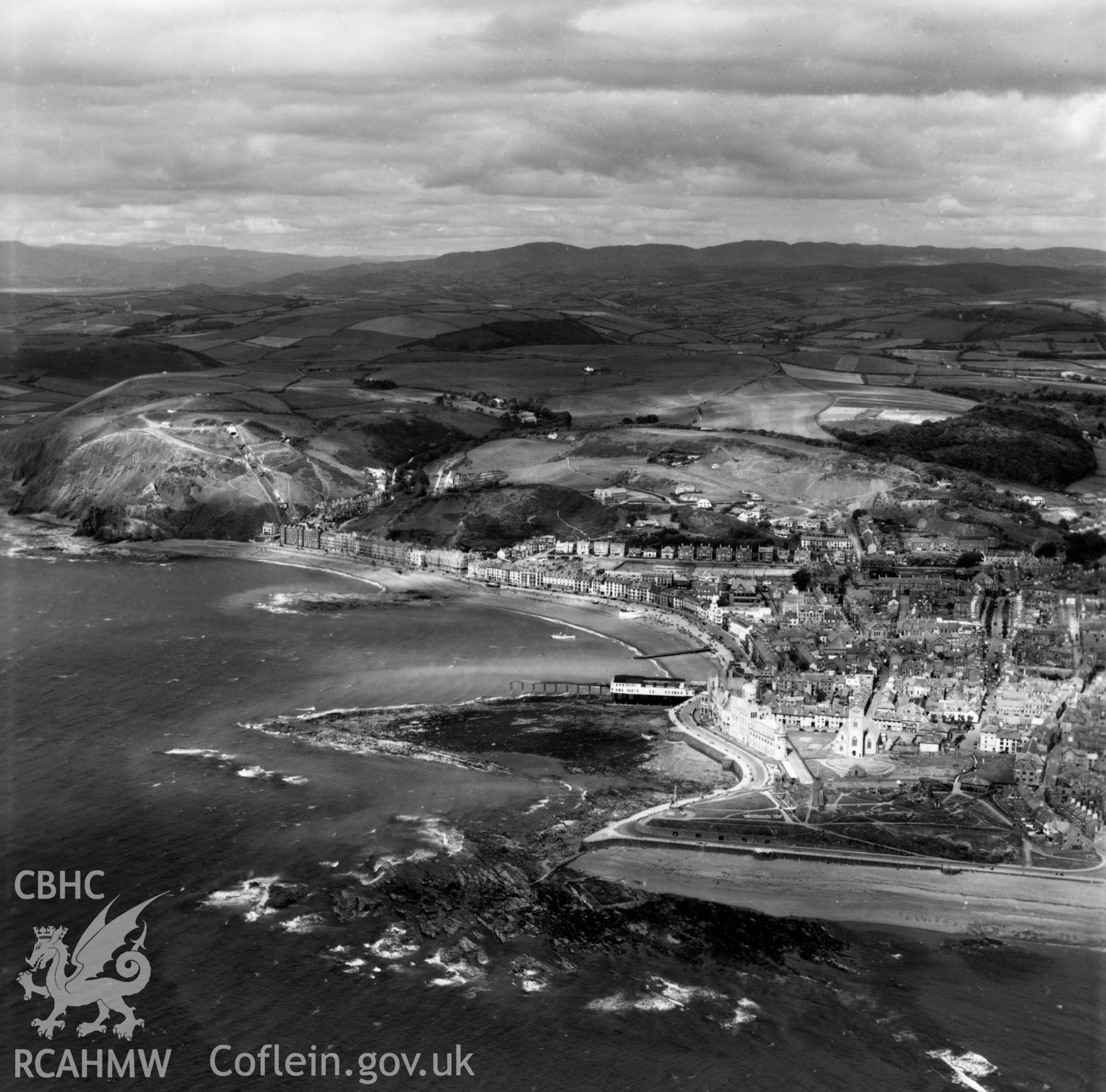 General view of Aberystwyth from the seafront looking north, showing town and hills to the north. Oblique aerial photograph, 5?" cut roll film.