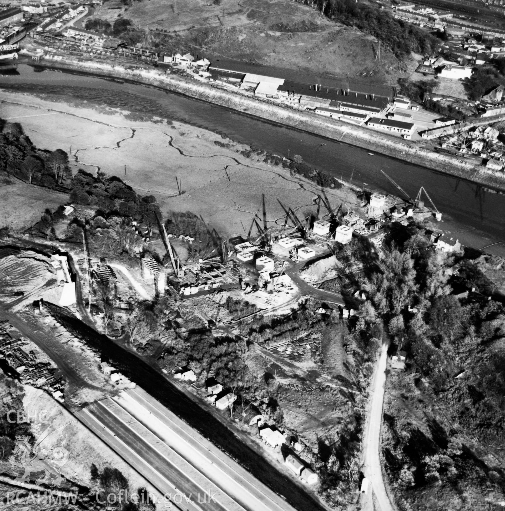 View of Briton Ferry and the Cleveland Bridge under construction. Oblique aerial photograph, 5?" cut roll film.