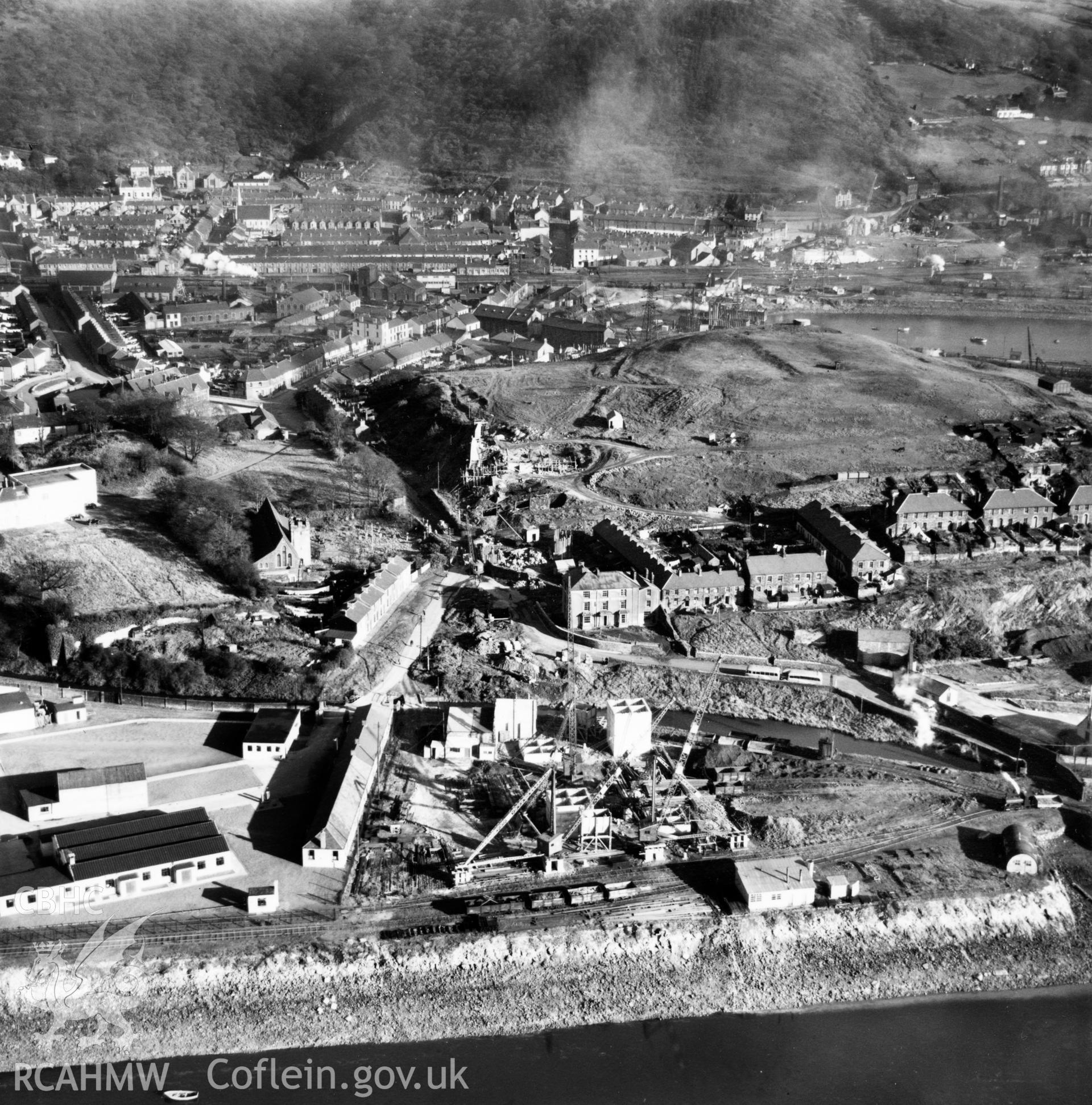 View of Briton Ferry and the Cleveland Bridge under construction. Oblique aerial photograph, 5?" cut roll film.