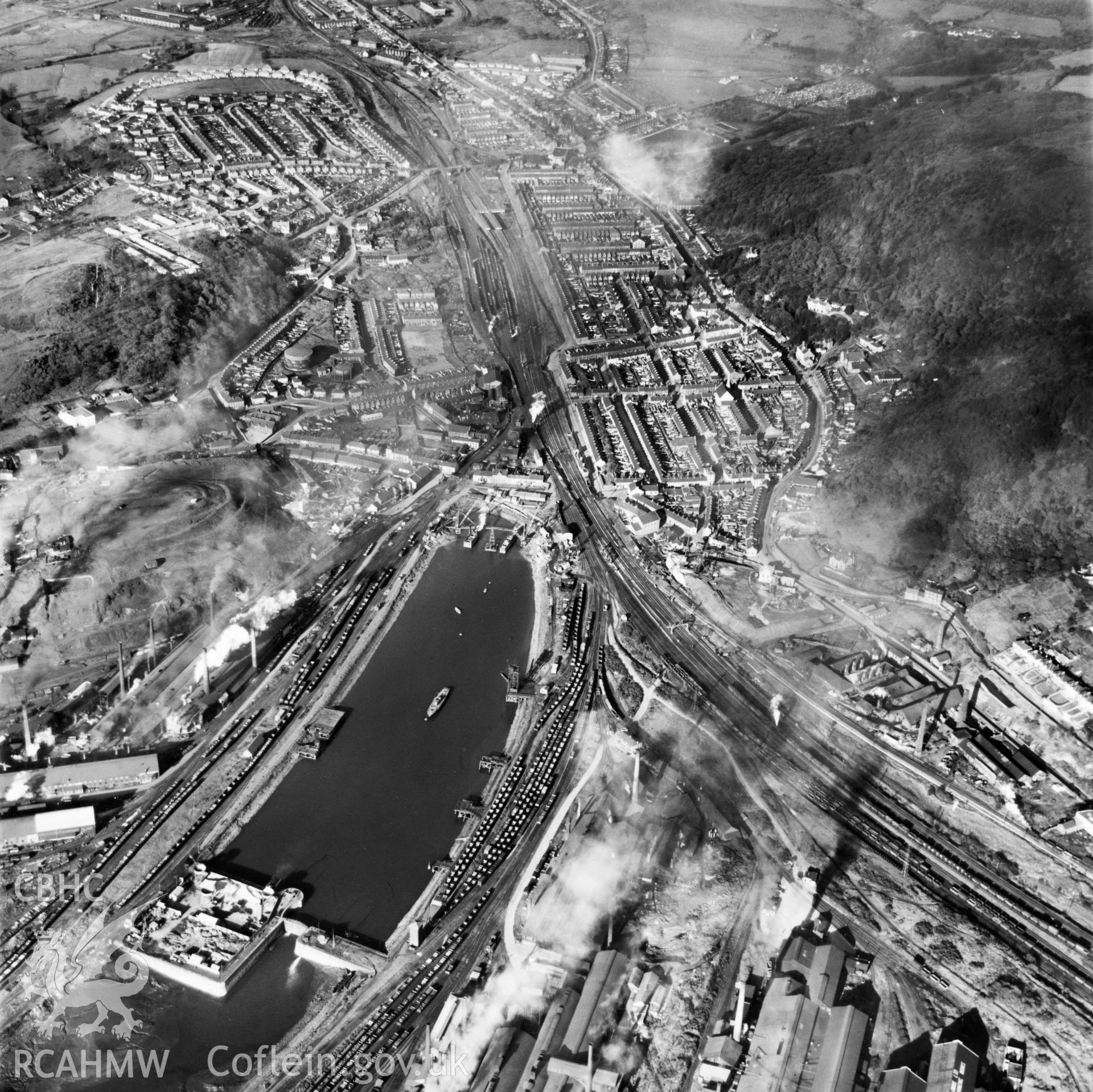 View of Briton Ferry and the Cleveland Bridge under construction. Oblique aerial photograph, 5?" cut roll film.