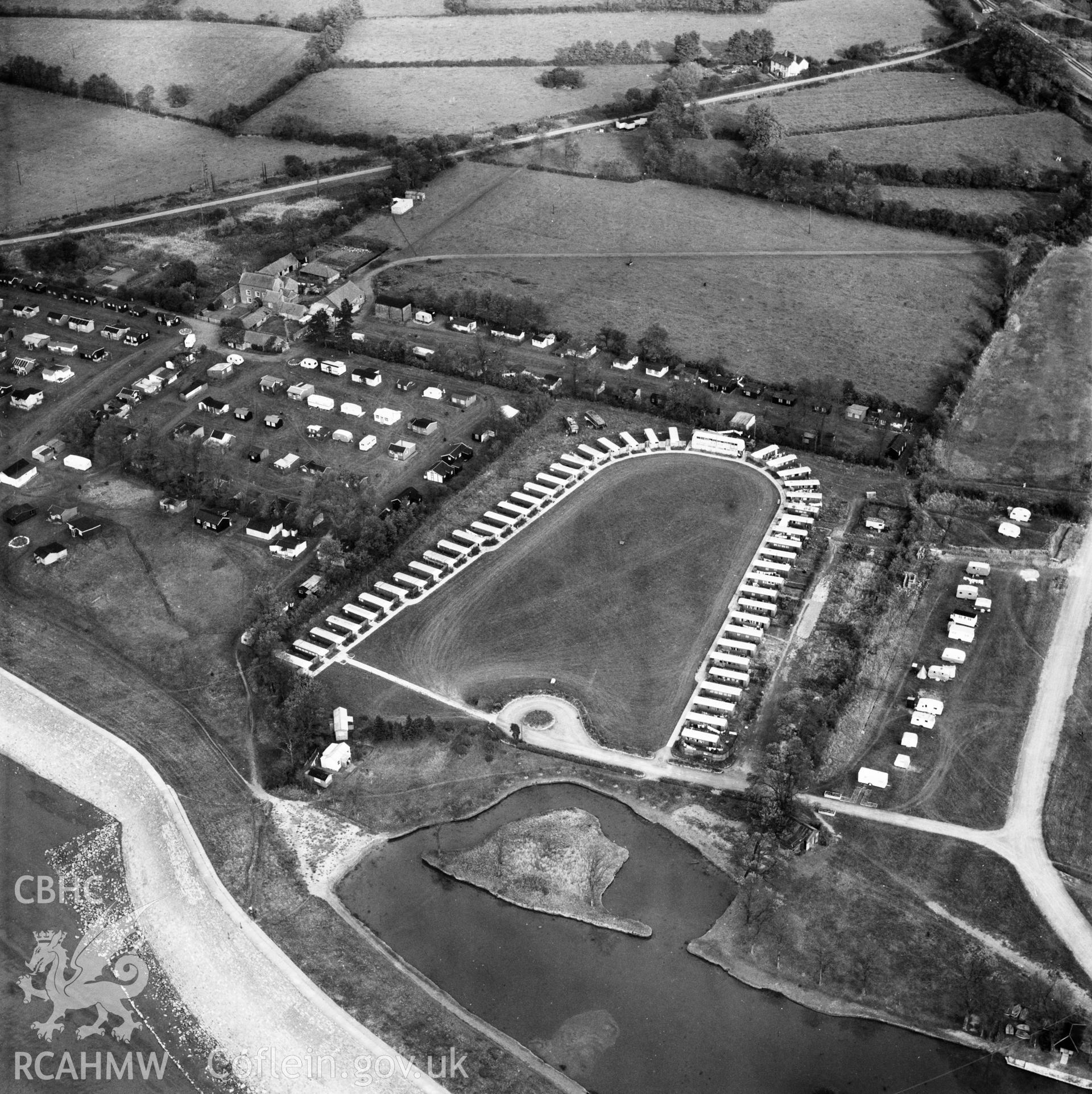 View of horseshoe shaped caravan park and prefabs located near Chepstow. Oblique aerial photograph, 5?" cut roll film.