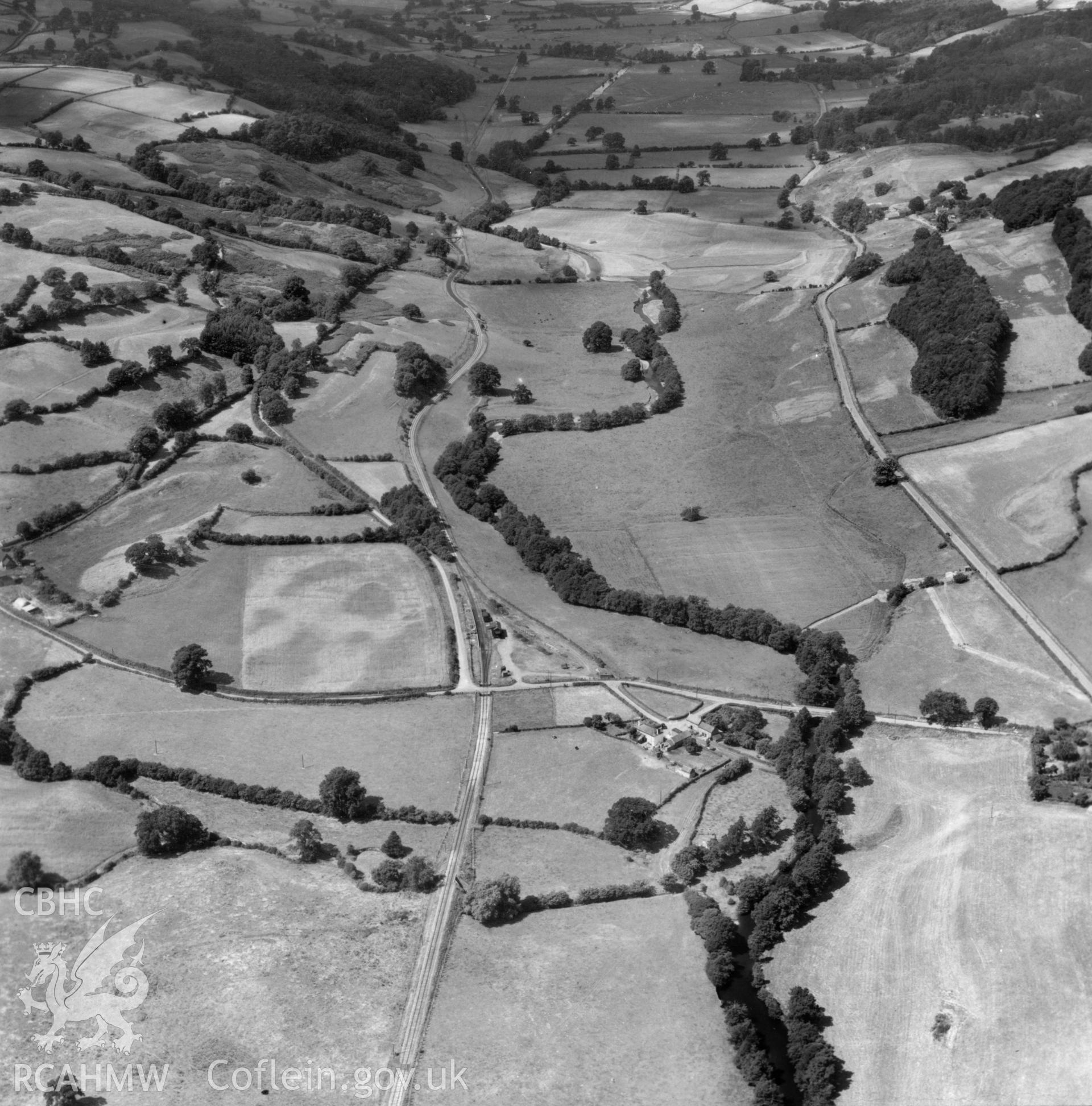 View of the Tanat valley showing railway and halt near Llanerch Emrys. Oblique aerial photograph.