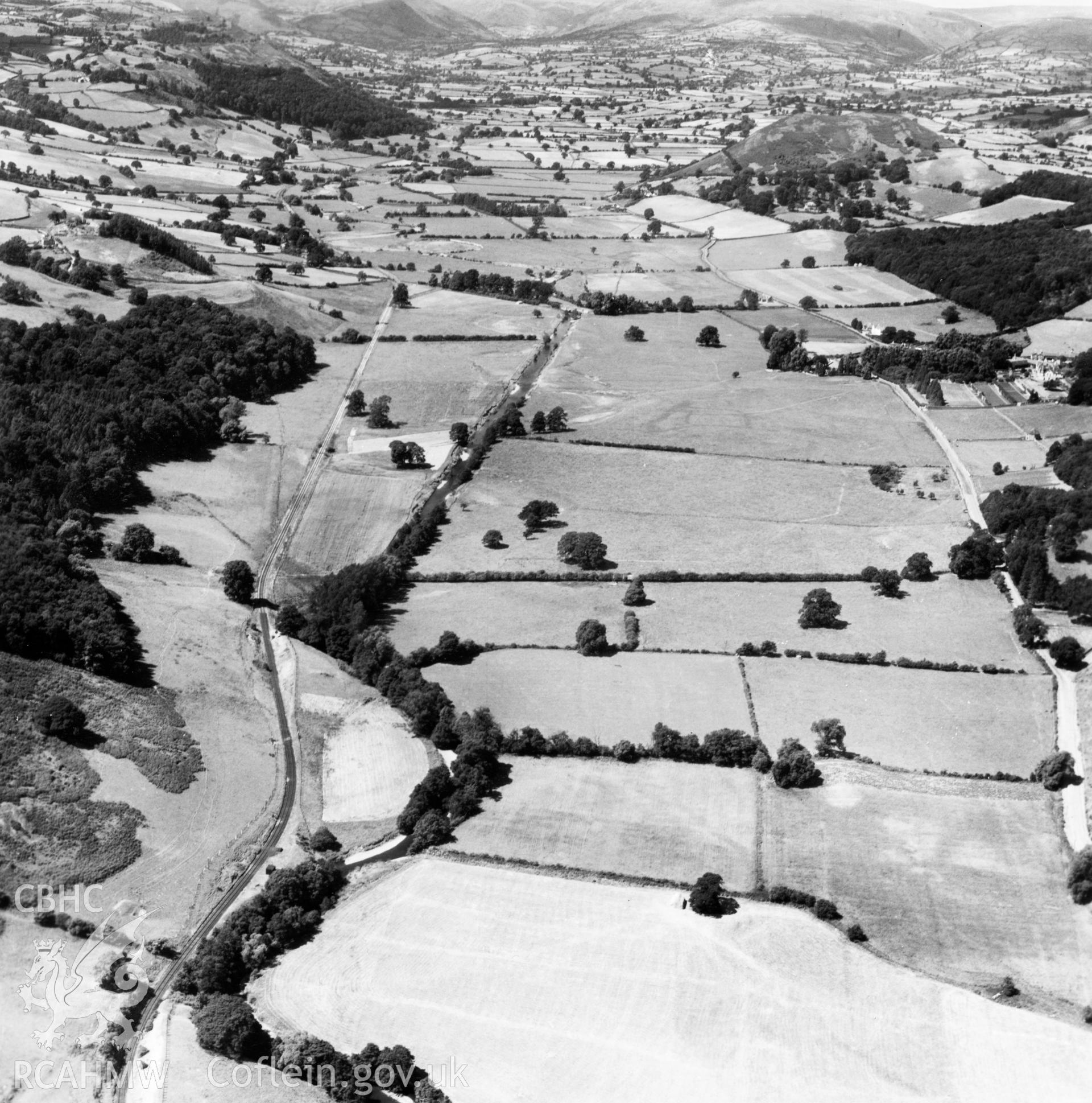 View of the Tanat valley looking west near Llangedwyn, showing railway. Oblique aerial photograph.