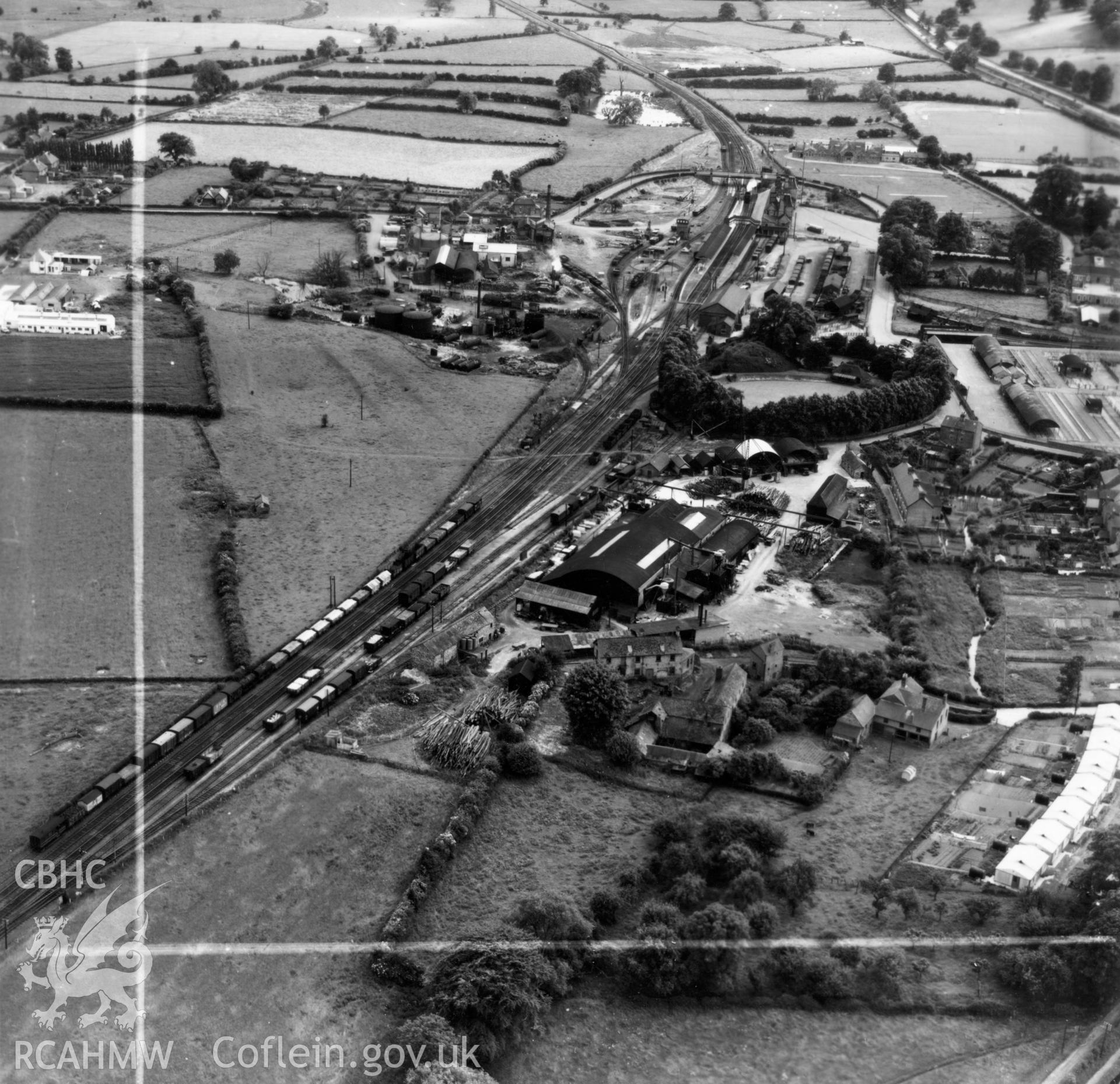 View of Welshpool showing Boys & Boden Ltd., Mill Lane, and prefab bungalows. Oblique aerial photograph, 5?" cut roll film.