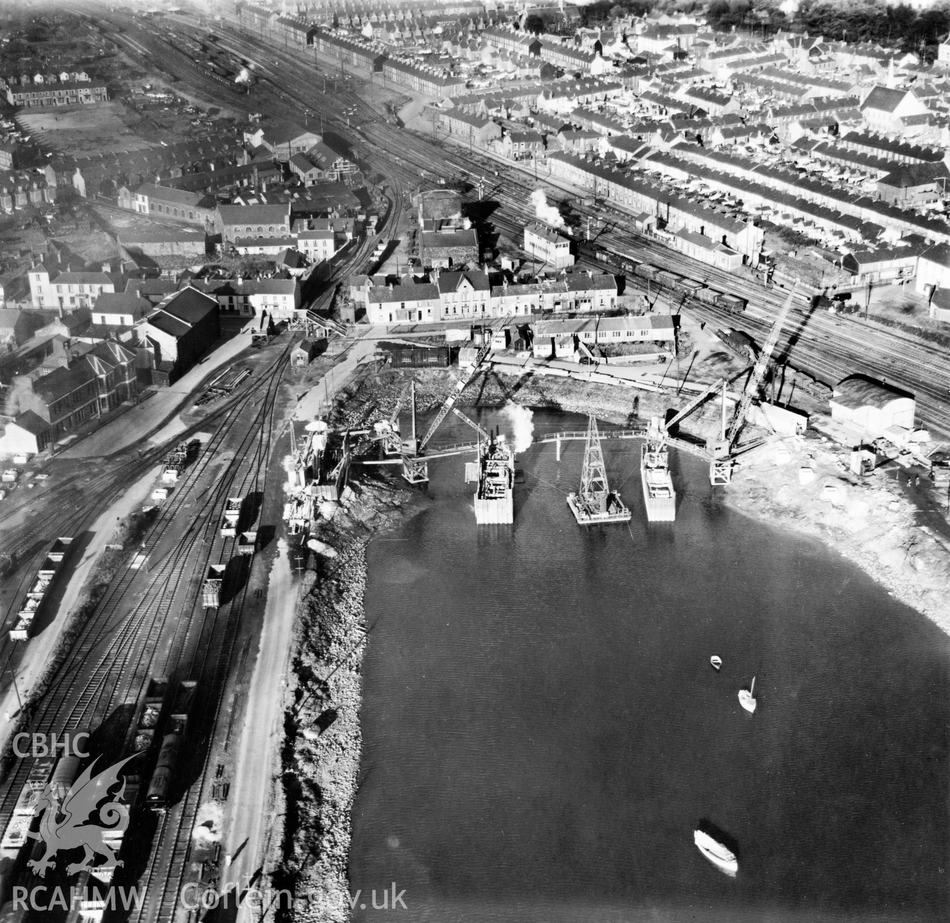 View of Briton Ferry and the Cleveland Bridge under construction. Oblique aerial photograph, 5?" cut roll film.