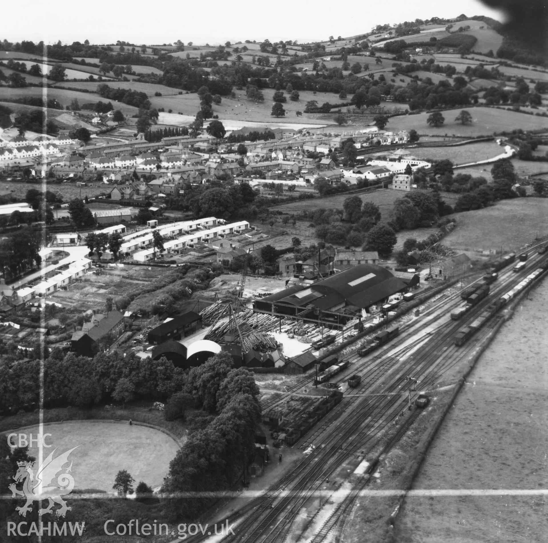 View of Welshpool showing Boys & Boden Ltd., Mill Lane, and prefab bungalows. Oblique aerial photograph, 5?" cut roll film.
