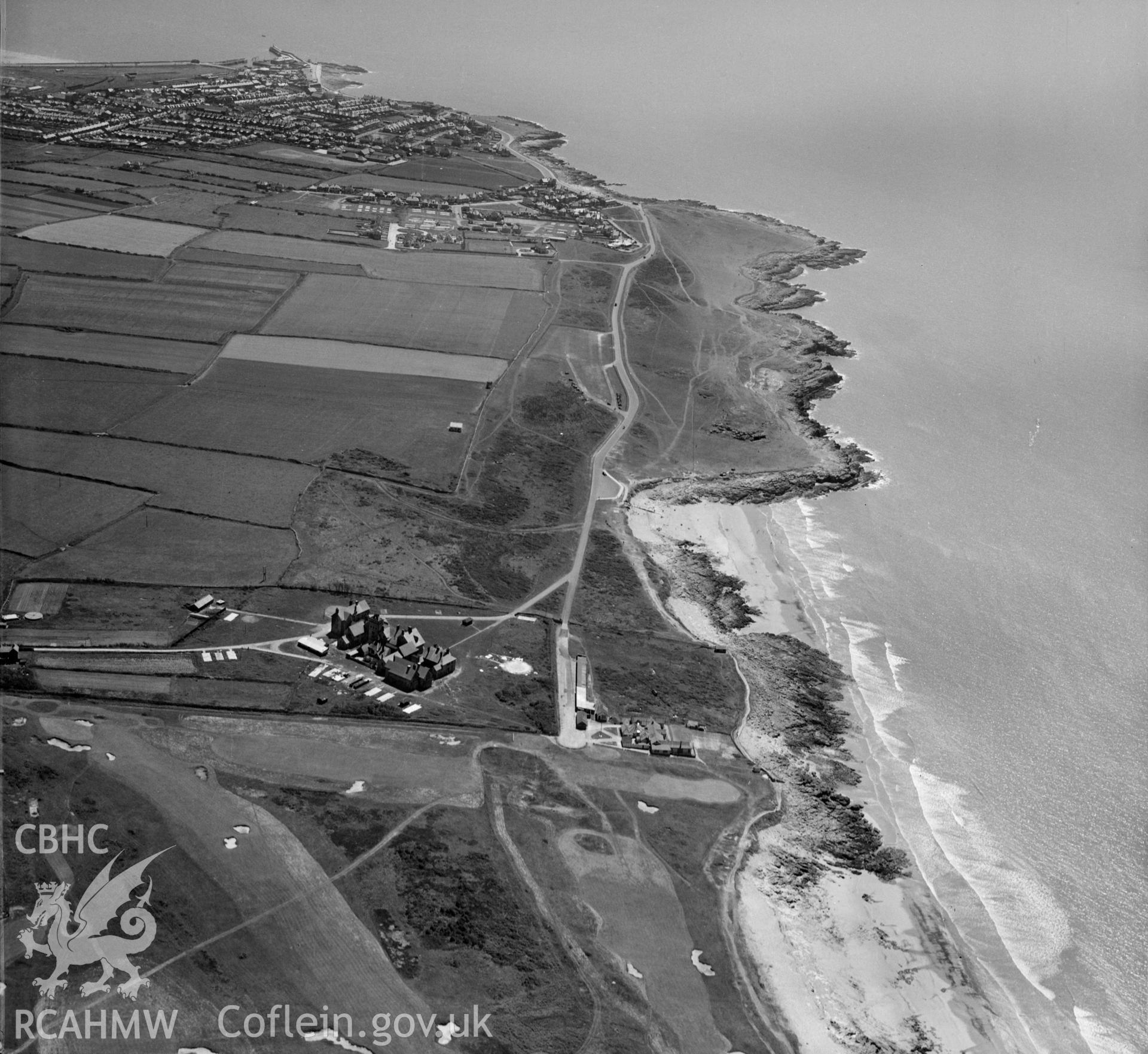 View of Royal Porthcawl golf club showing distant Porthcawl in the distance