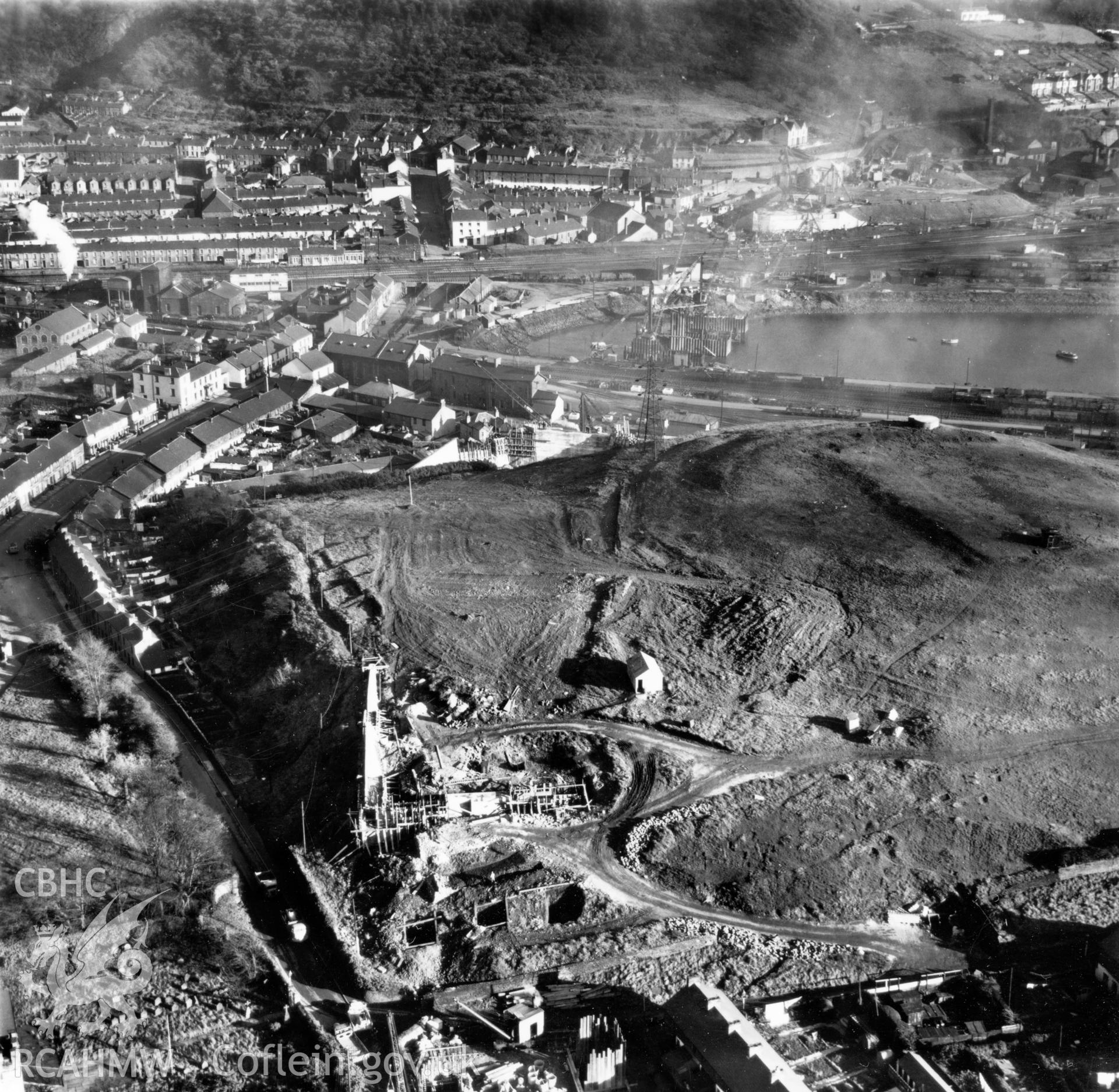 View of Briton Ferry and the Cleveland Bridge under construction. Oblique aerial photograph, 5?" cut roll film.