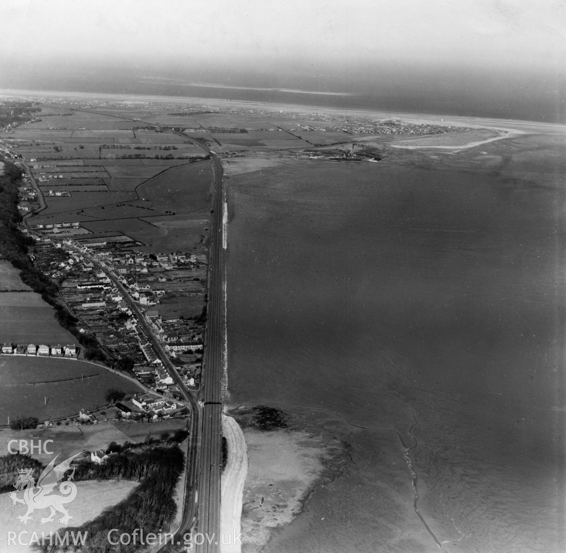 View of Ffynnongroyw and railway looking northwest towards Point of Ayr. Oblique aerial photograph, 5?" cut roll film.