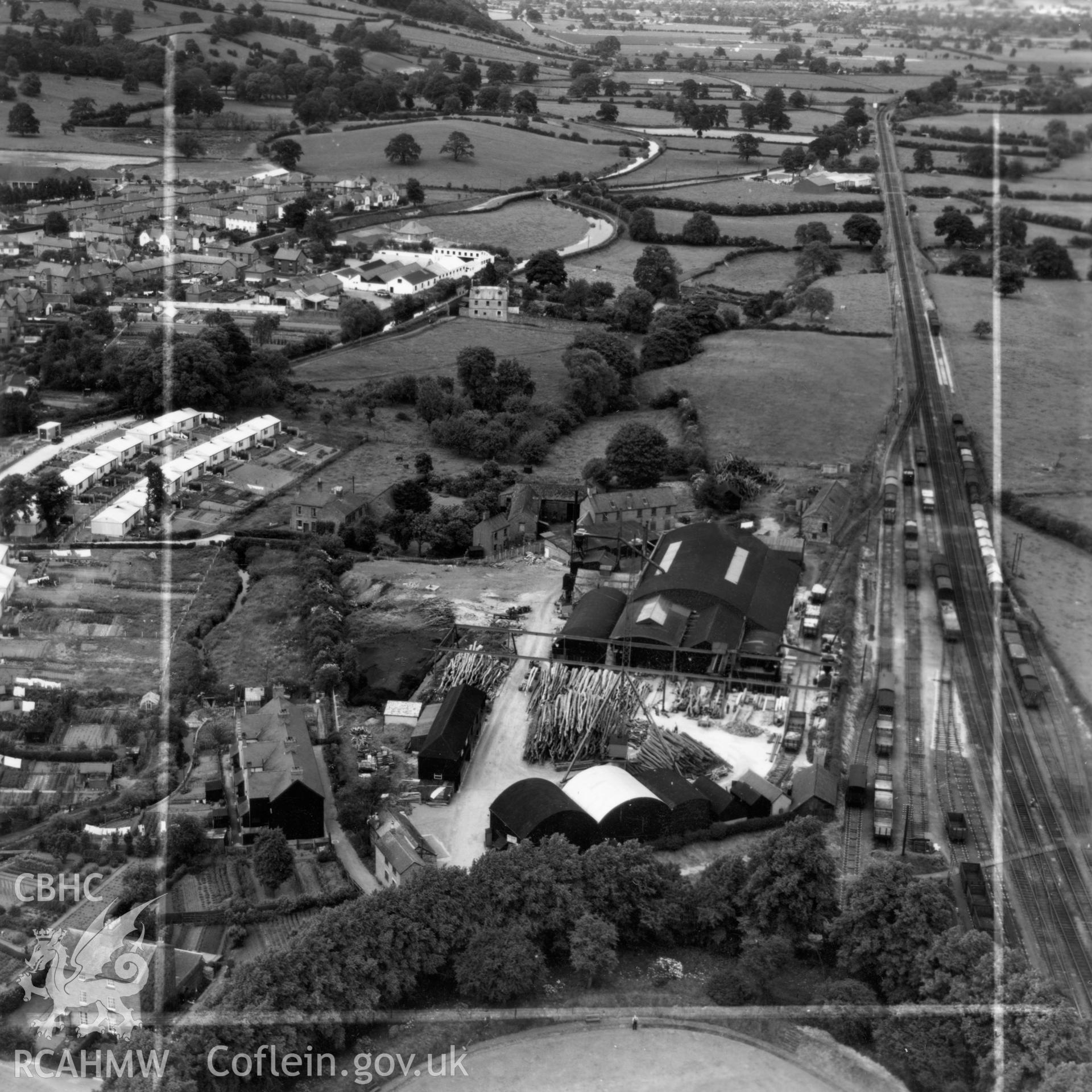 View of Welshpool showing Boys & Boden Ltd., Mill Lane, and prefab bungalows. Oblique aerial photograph, 5?" cut roll film.