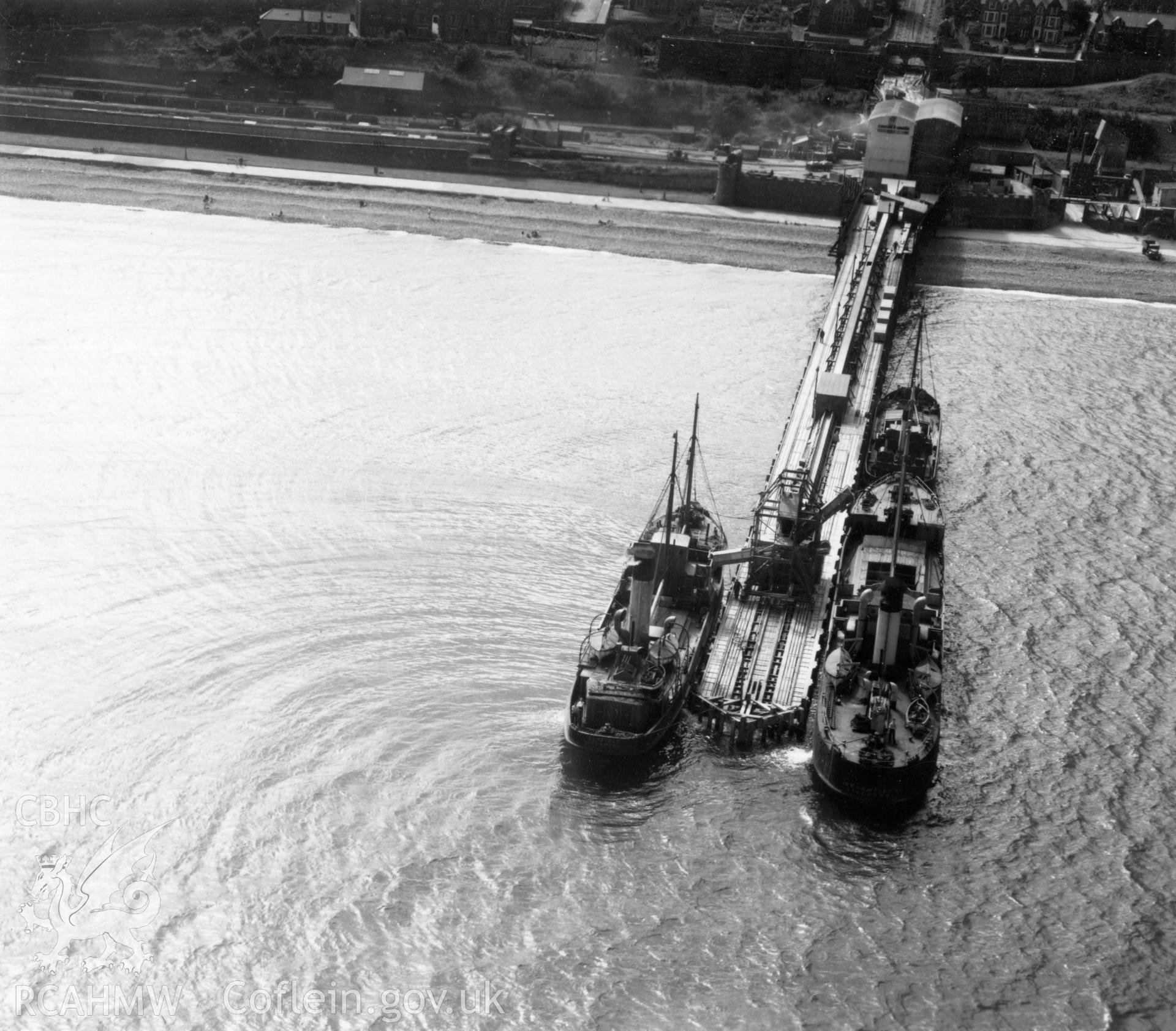 Close view of Graiglwyd jetty at Penmaenmawr with moored cargo ships. Oblique aerial photograph, 5?" cut roll film.