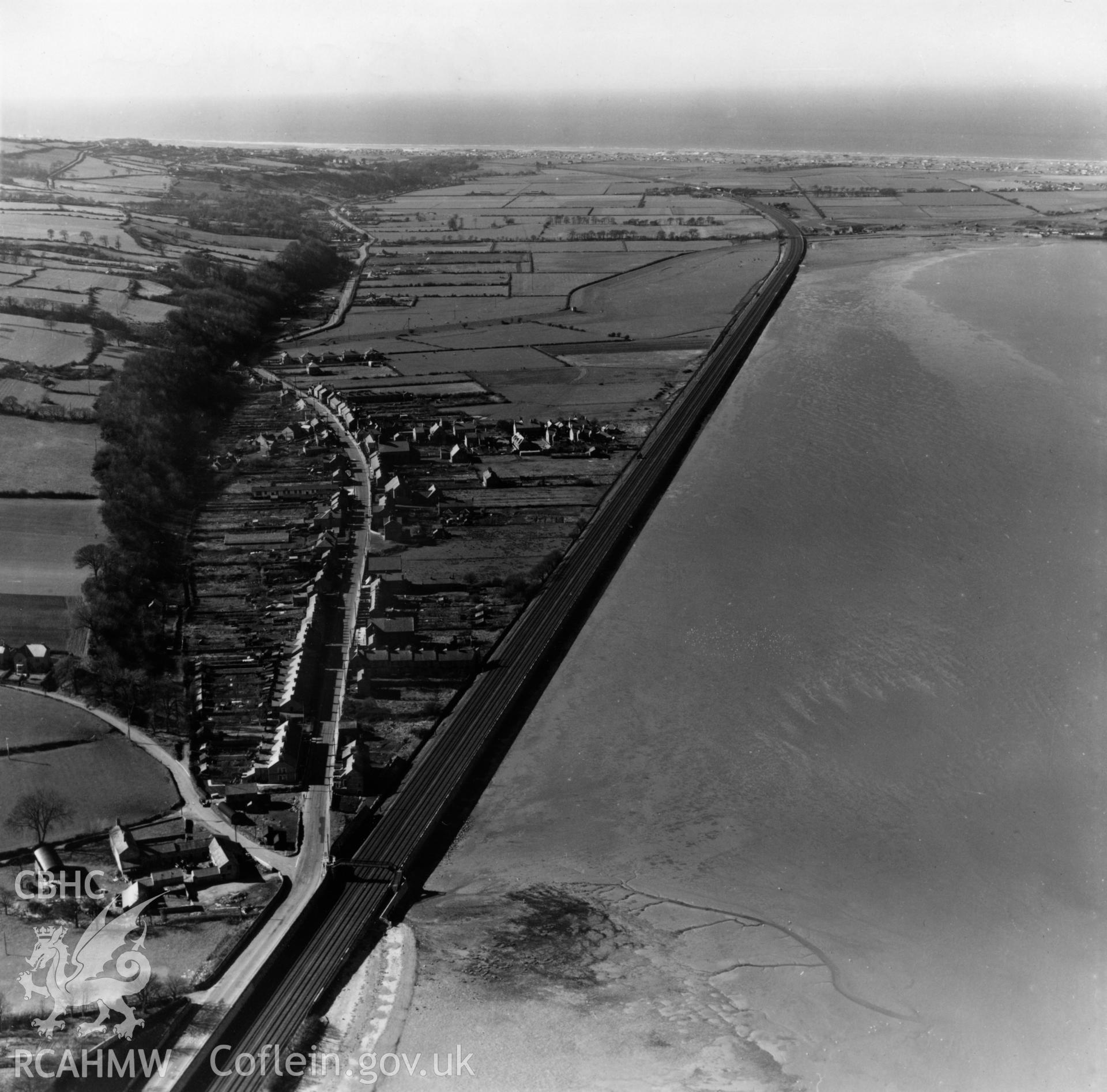 View of Ffynnongroyw and railway looking northwest towards Point of Ayr. Oblique aerial photograph, 5?" cut roll film.