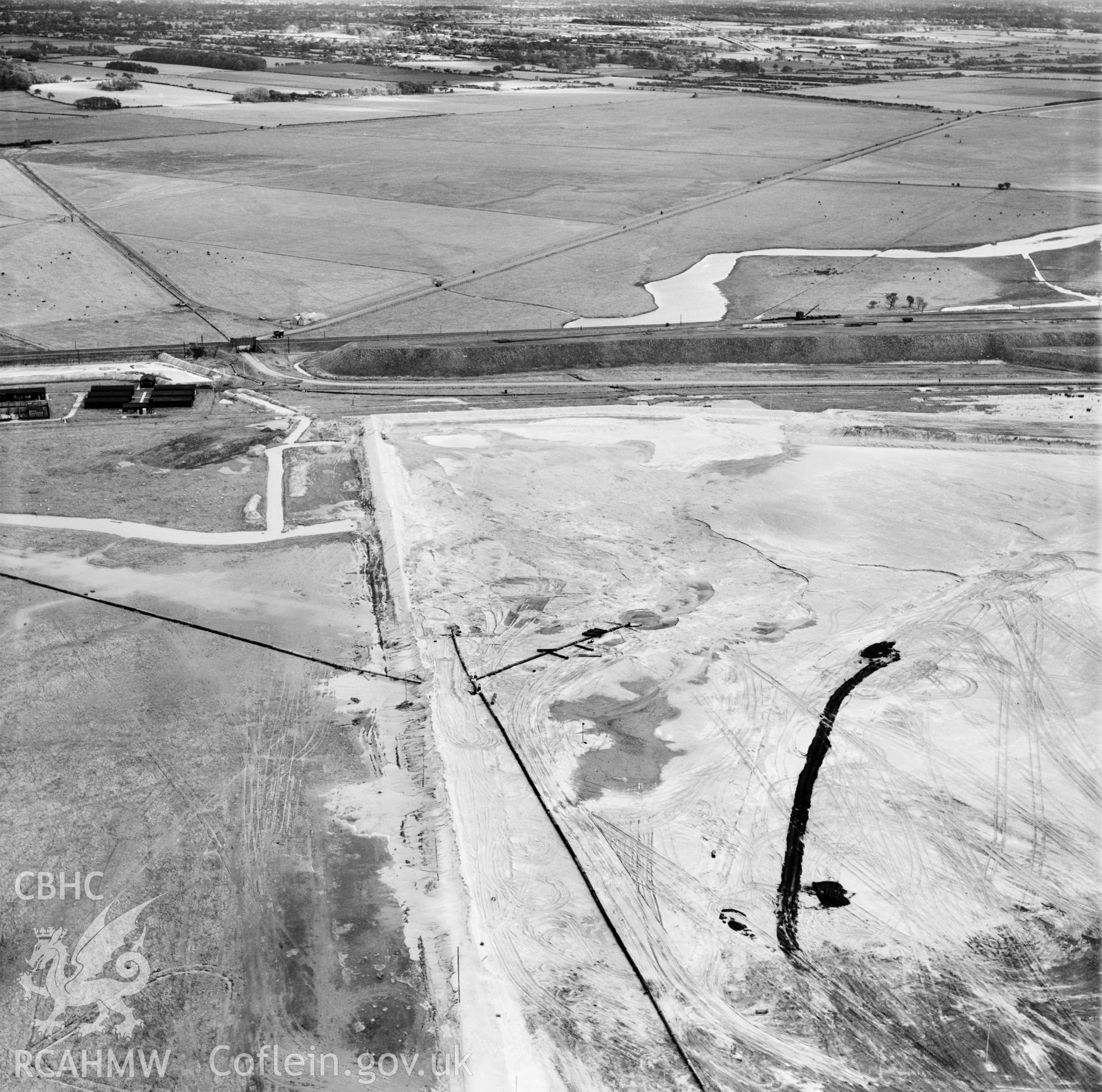 View of the dredging of the Shotton steelworks site (commissioned by Westminster Dredging Co.). Oblique aerial photograph, 5?" cut roll film.