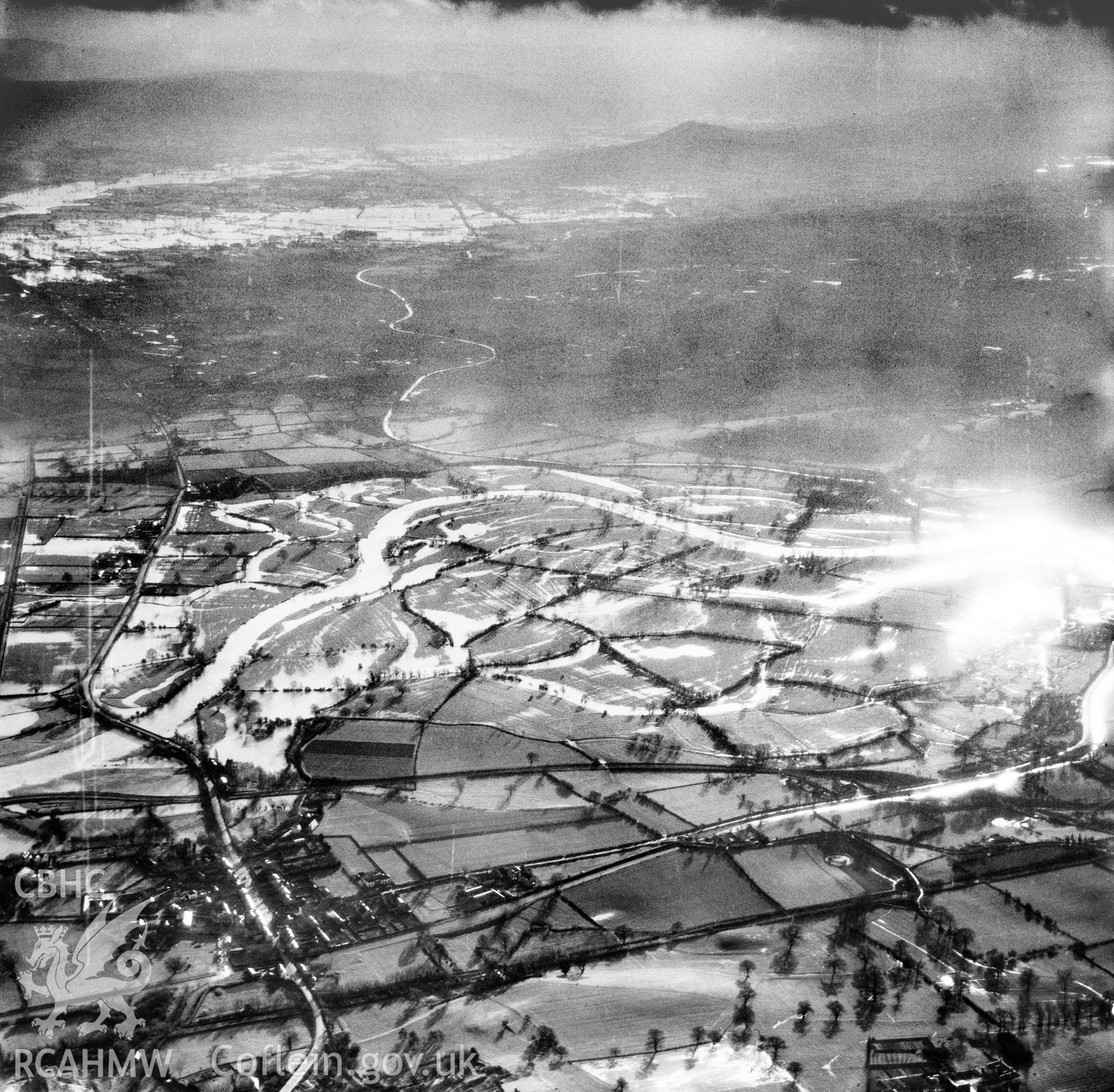 View of the river Severn in flood in the Criggion and Breiddan Hill area. Oblique aerial photograph, 5?" cut roll film.