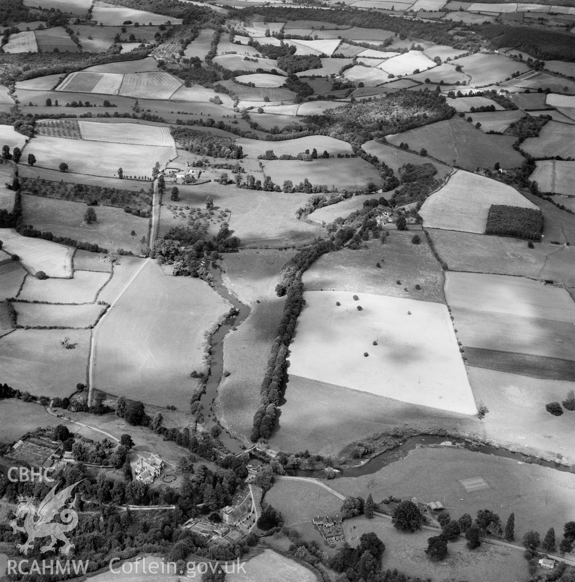 Distant view of Rockfield Park, Rockfield, commissioned by D H Lloyd Esq.. Oblique aerial photograph, 5?" cut roll film.