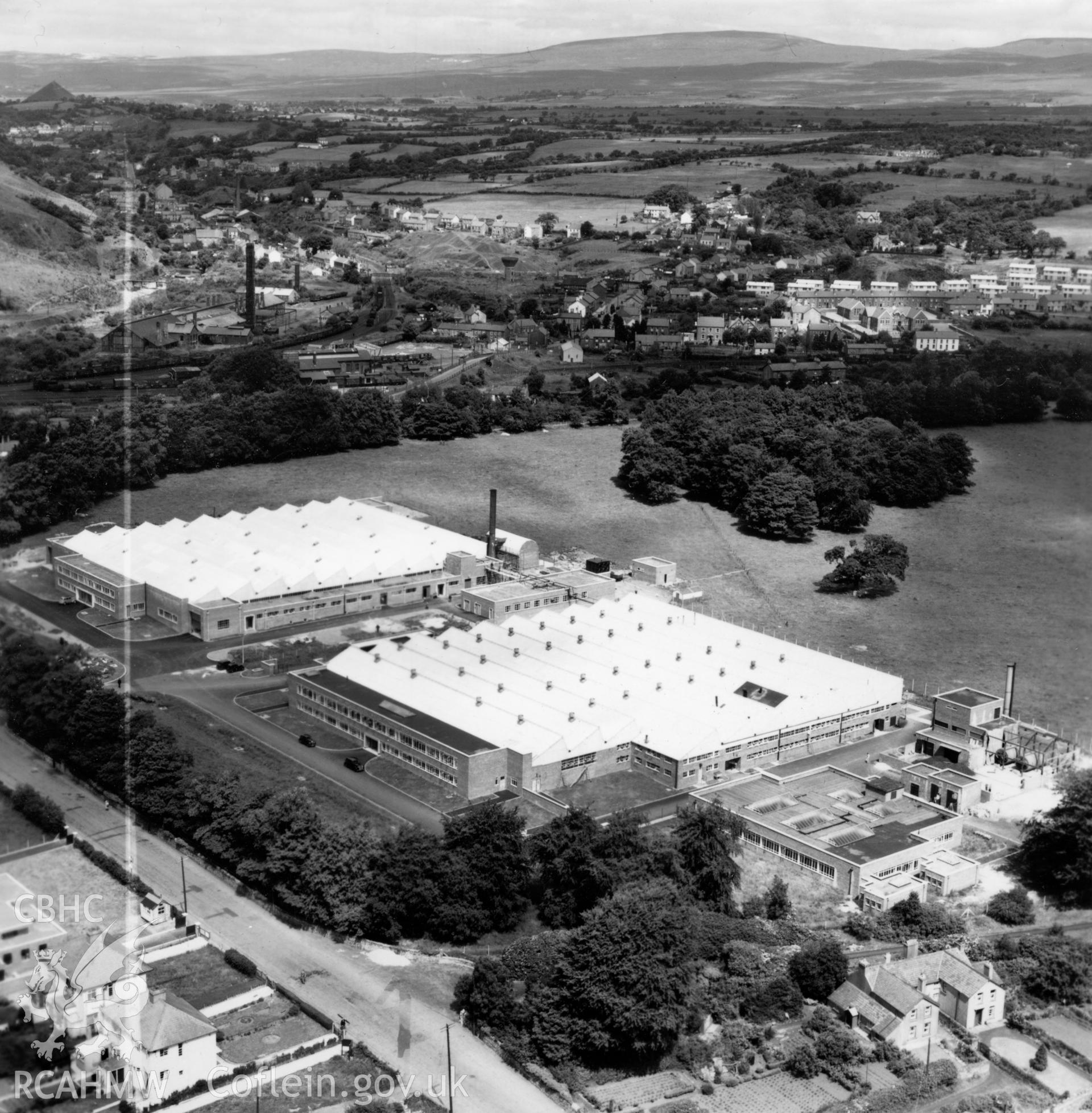 View of Smith's Clock and the Anglo-Welsh watch factories, Gurnos, showing Gurnos Tin and Brick works in the distance (commissioned by William Cowlin & Son Ltd.). Oblique aerial photograph, 5?" cut roll film.