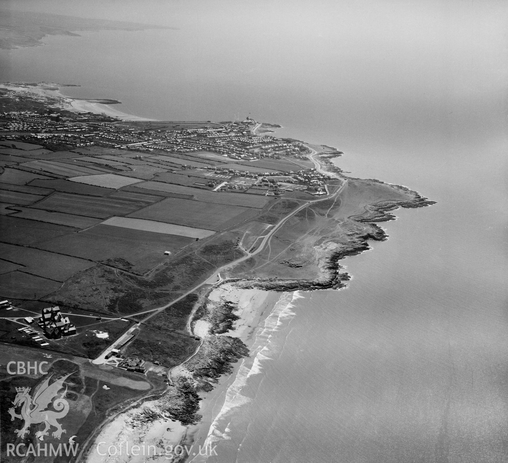 View of Royal Porthcawl golf club showing distant Porthcawl in the distance