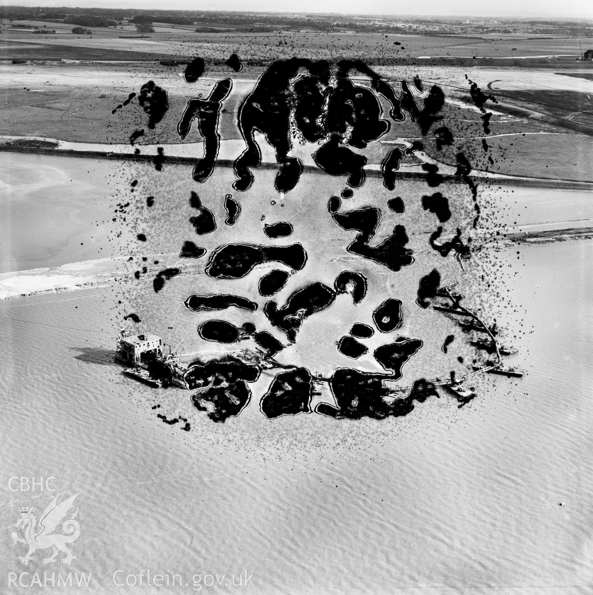 View of the dredging of the Shotton steelworks site (commissioned by Westminster Dredging Co.). Oblique aerial photograph, 5?" cut roll film.