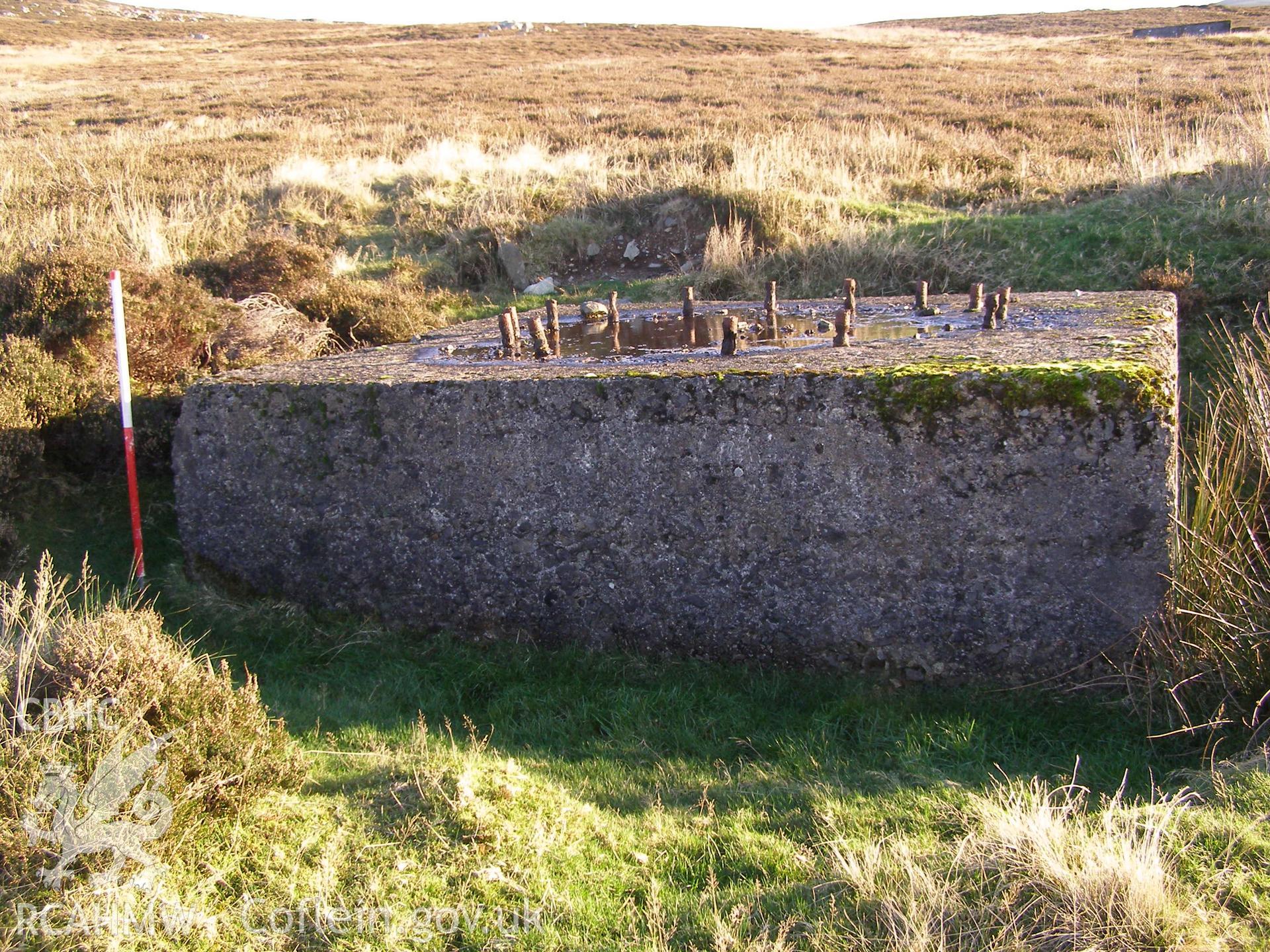 Digital colour photograph of Cefn Du Radio Station, concrete base IXL taken on 10/12/2007 by P.J. Schofield during the Snowdon North West Upland Survey undertaken by Oxford Archaeology North.