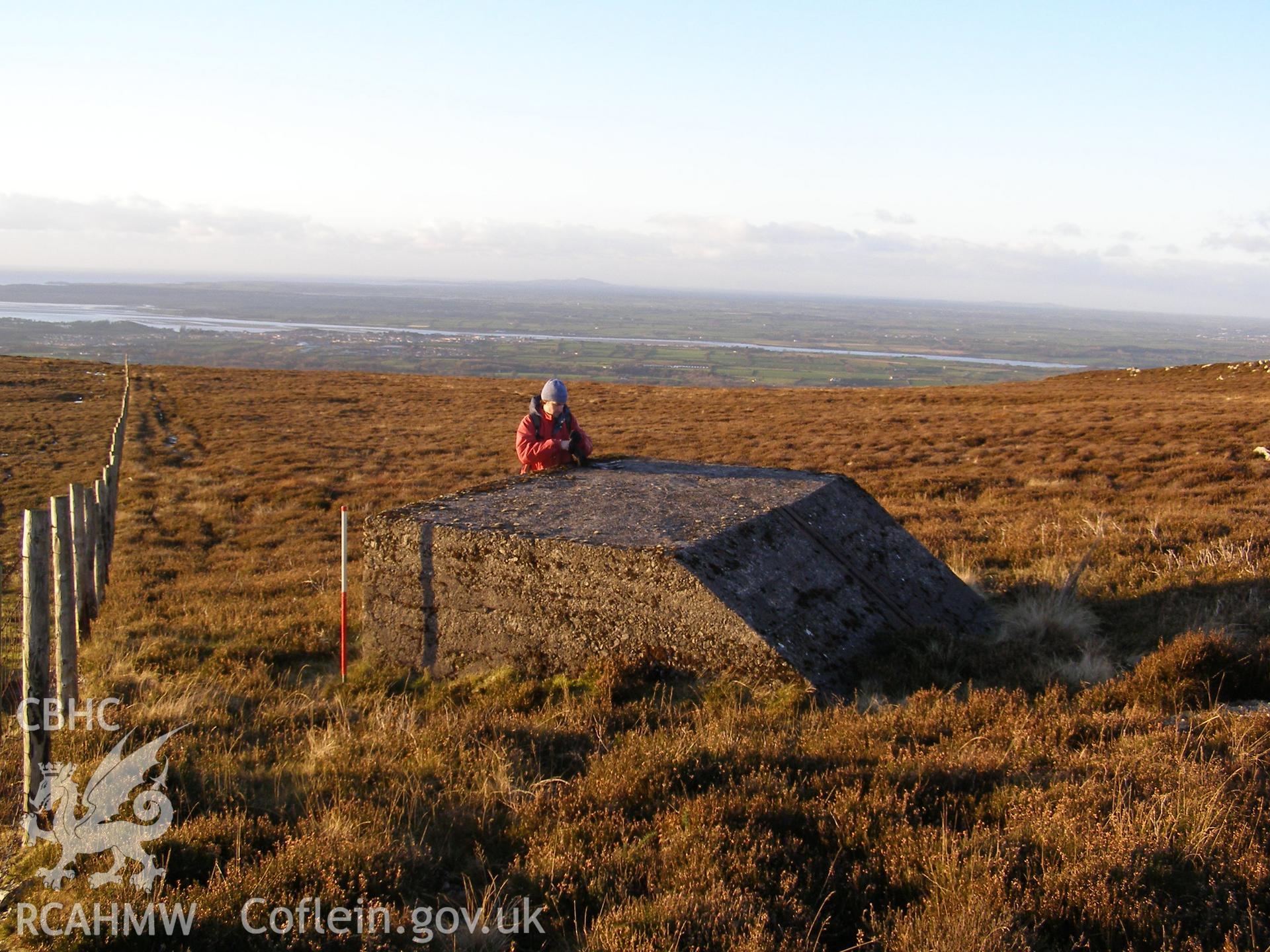 Digital colour photograph of Cefn Du Radio Station, concrete base LVII taken on 10/12/2007 by P.J. Schofield during the Snowdon North West Upland Survey undertaken by Oxford Archaeology North.