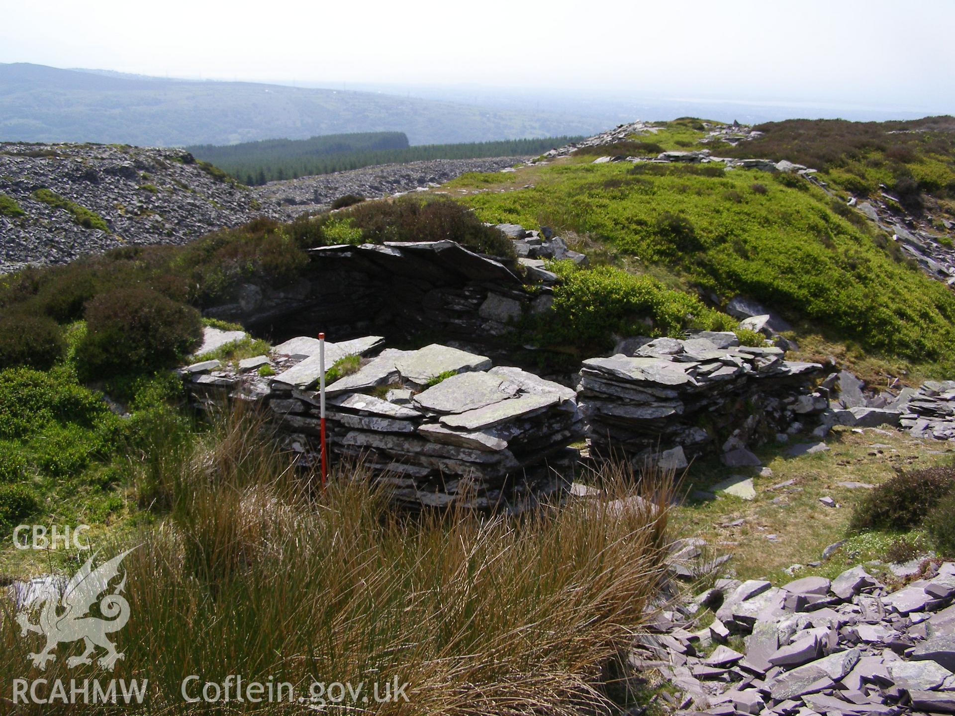 Digital colour photograph of Chwarel Fawr labourers shelter VI taken on 07/06/2007 by P.J. Schofield during the Snowdon North West Upland Survey undertaken by Oxford Archaeology North.