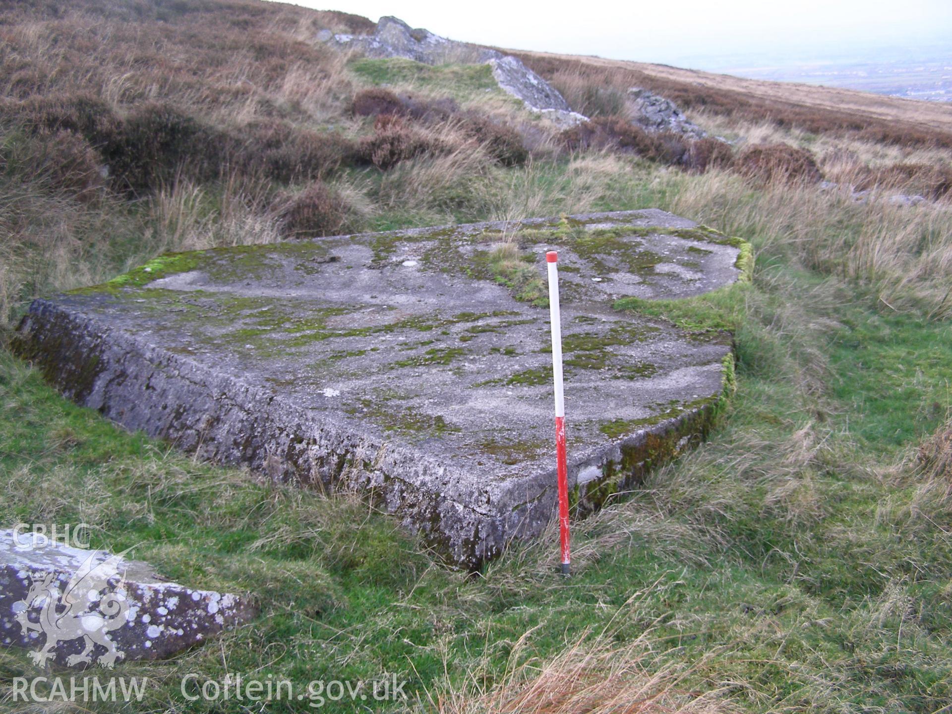 Digital colour photograph of Cefn Du Radio Station, concrete base LXIX taken on 13/12/2007 by P.J. Schofield during the Snowdon North West Upland Survey undertaken by Oxford Archaeology North.