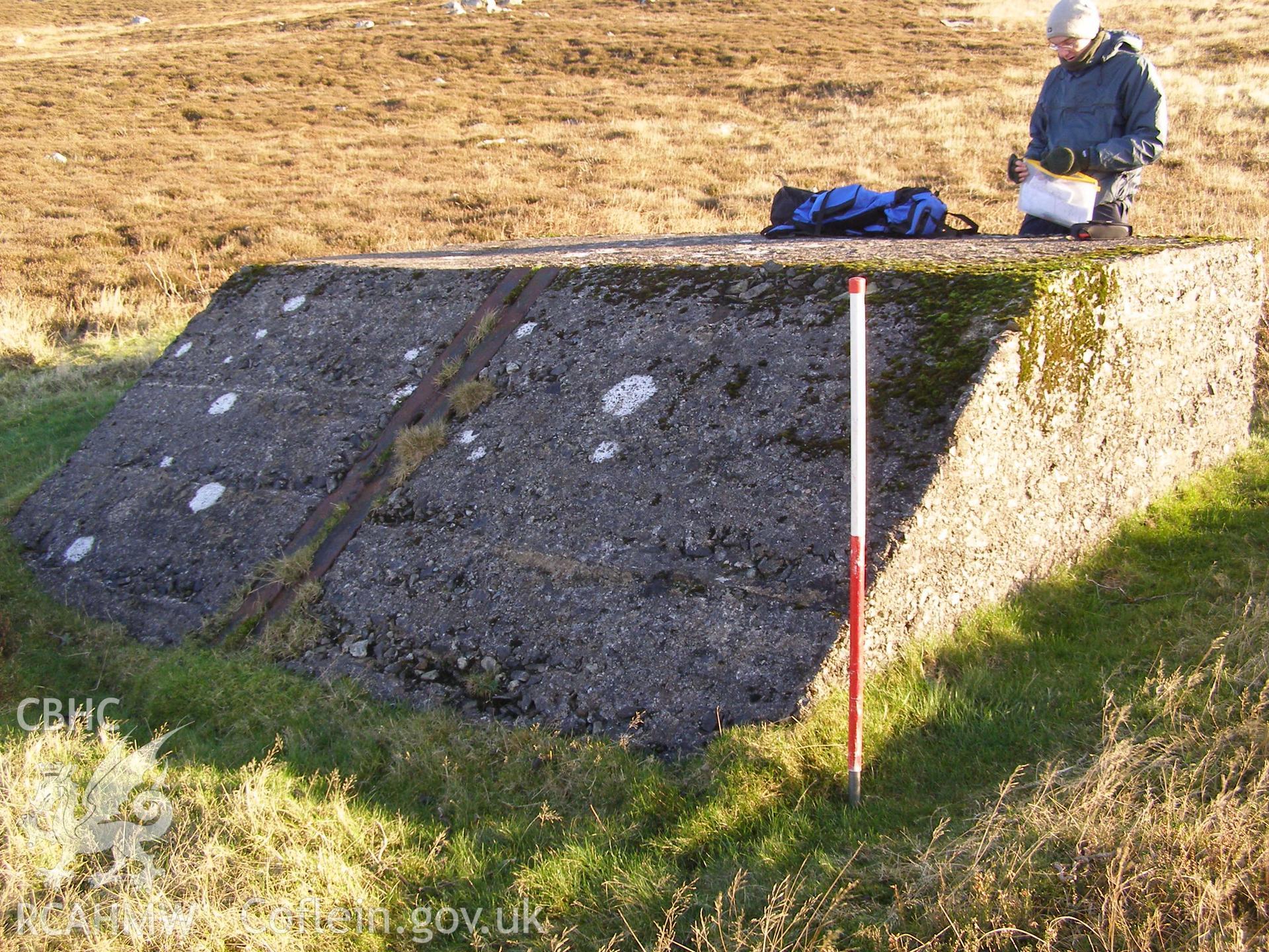 Digital colour photograph of Cefn Du Radio Station, concrete base XXXVII taken on 10/12/2007 by P.J. Schofield during the Snowdon North West Upland Survey undertaken by Oxford Archaeology North.