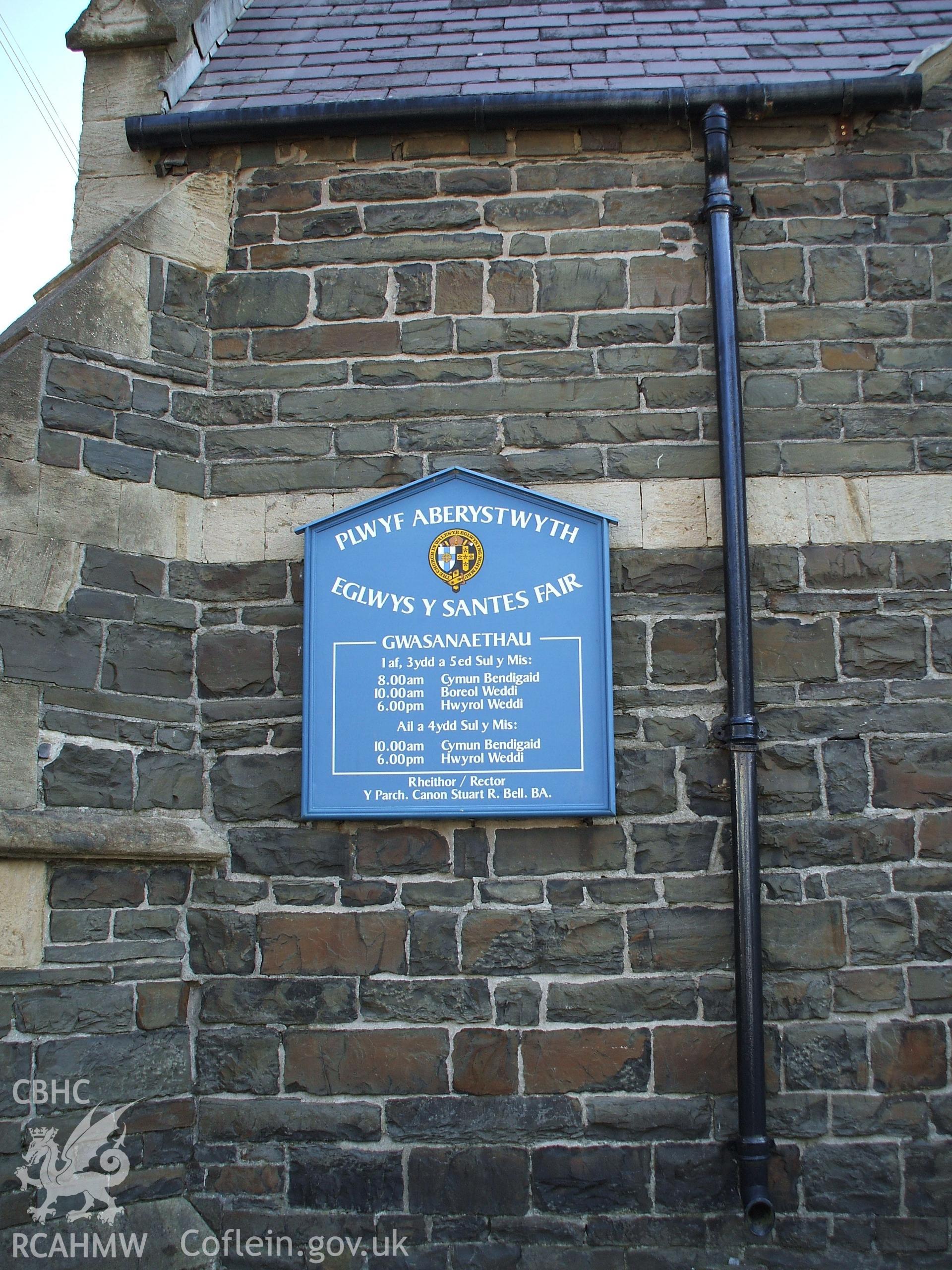 Colour digital photograph showing a sign on the wall of St. Mary's Church, Aberystwyth. The sign is entitled, "Plwyf Aberystwyth, Eglwys y Santes fair."