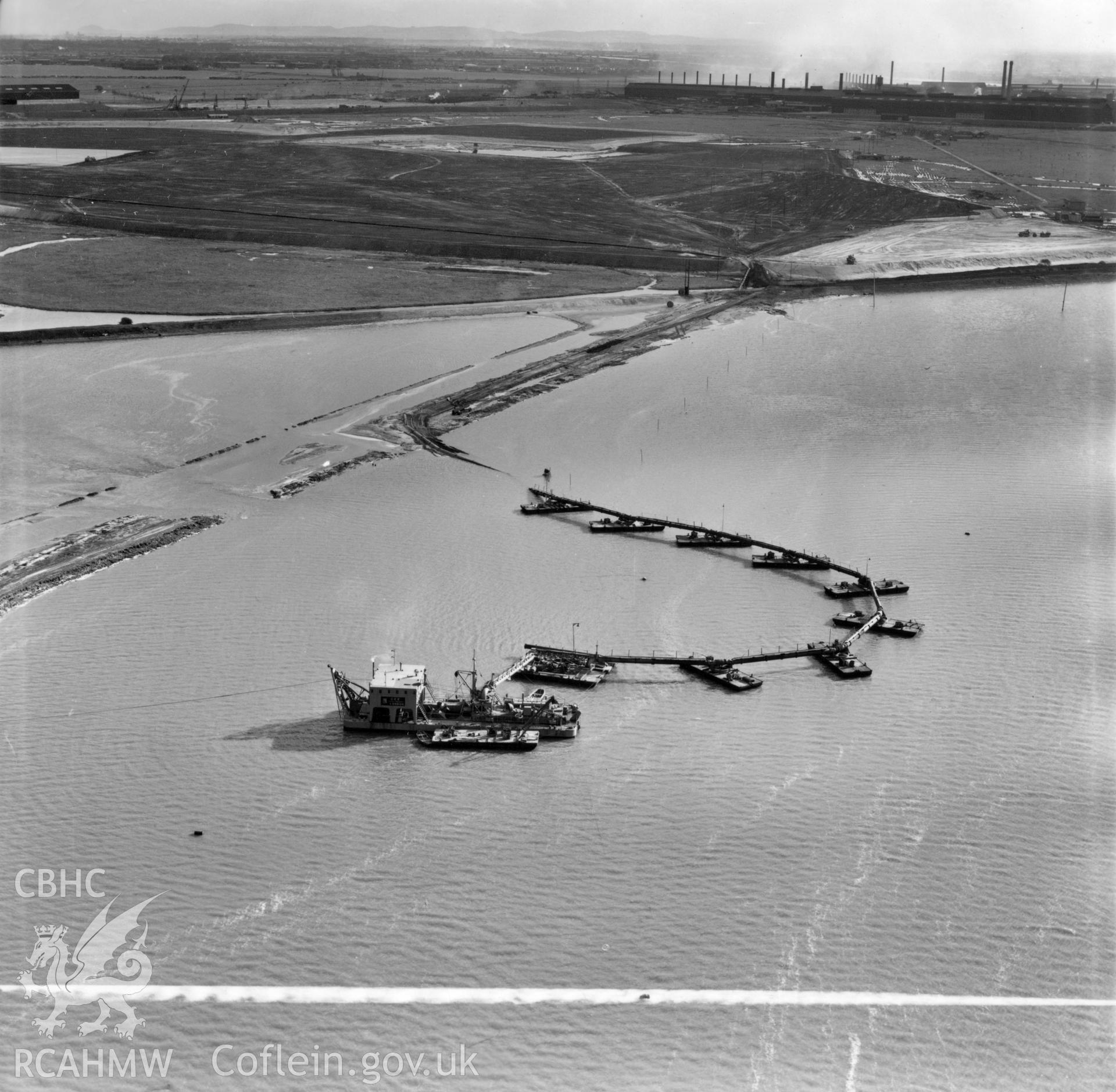 View of floating pontoon and dreging vessel, during dreging work for Shotton Steelworks. Commissioned by the Westminster Dredging Co. Ltd.. Oblique aerial photograph, 5?" cut roll film.