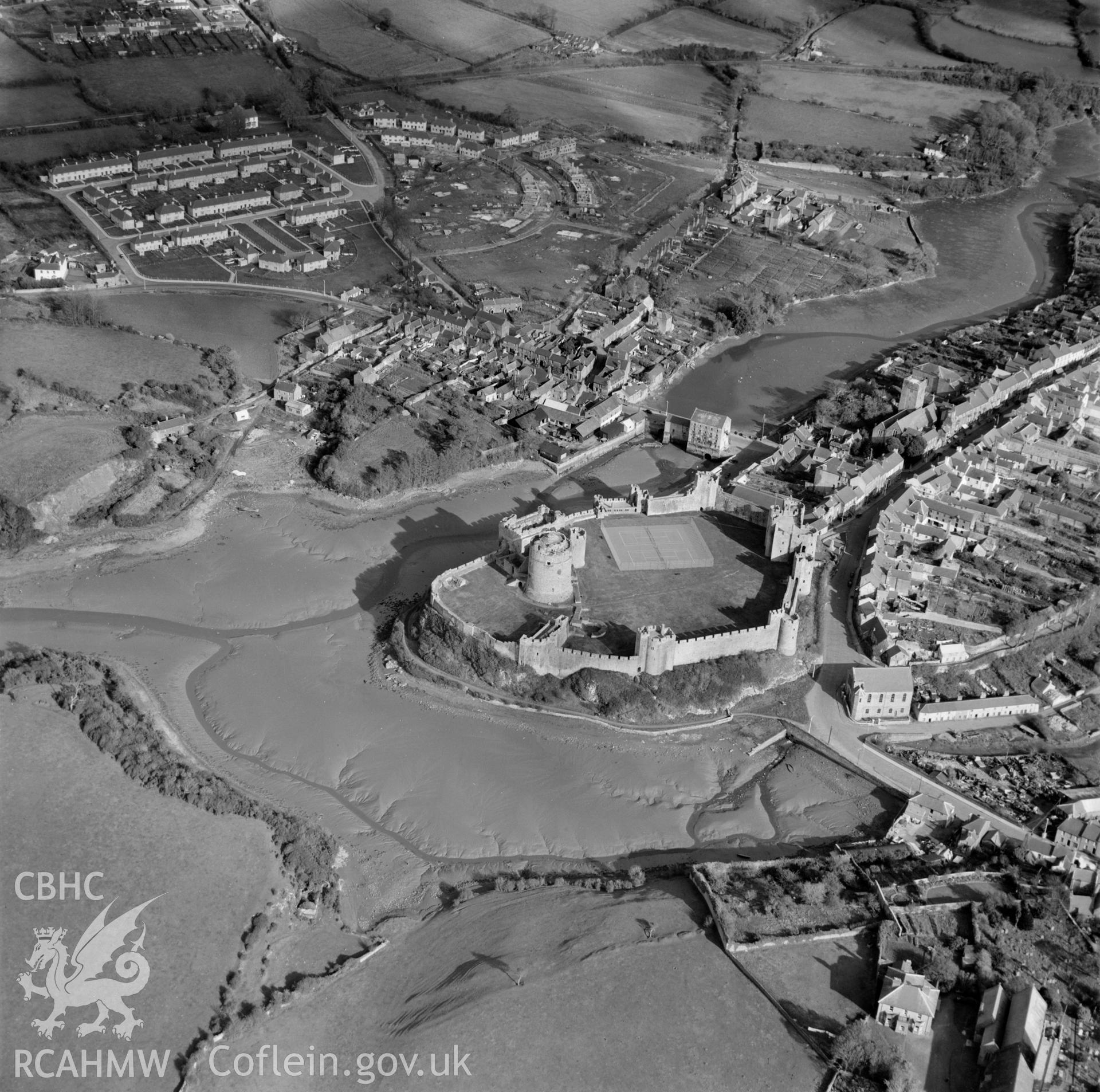 View of Pembroke showing castle with tennis court and newly built housing estate