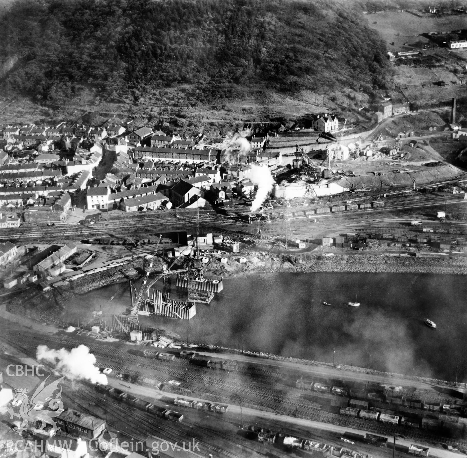 View of Briton Ferry and the Cleveland Bridge under construction. Oblique aerial photograph, 5?" cut roll film.