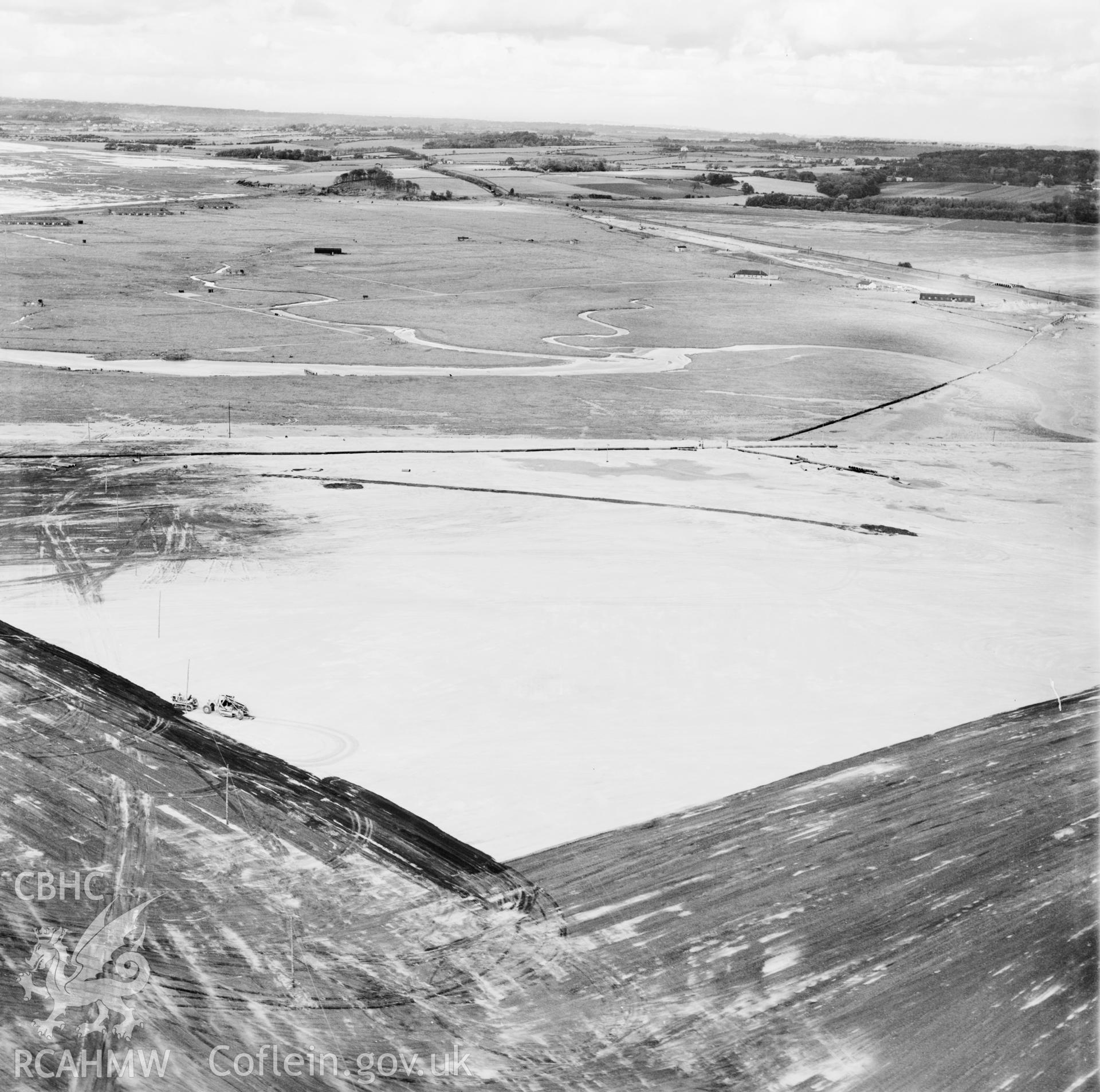 View of the dredging of the Shotton steelworks site (commissioned by Westminster Dredging Co.). Oblique aerial photograph, 5?" cut roll film.