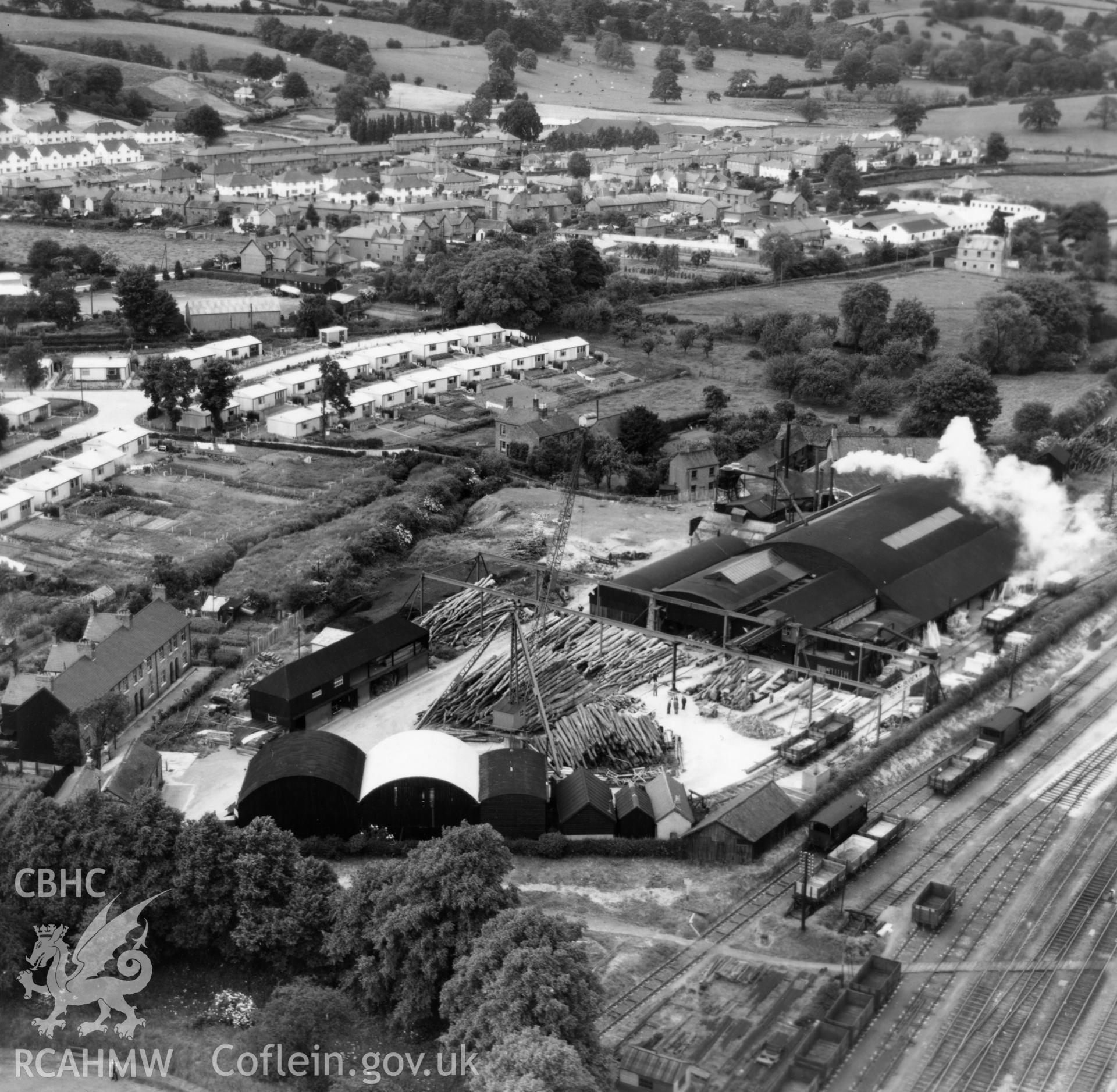 View of Welshpool showing Boys & Boden Ltd., Mill Lane, and prefab bungalows. Oblique aerial photograph, 5?" cut roll film.