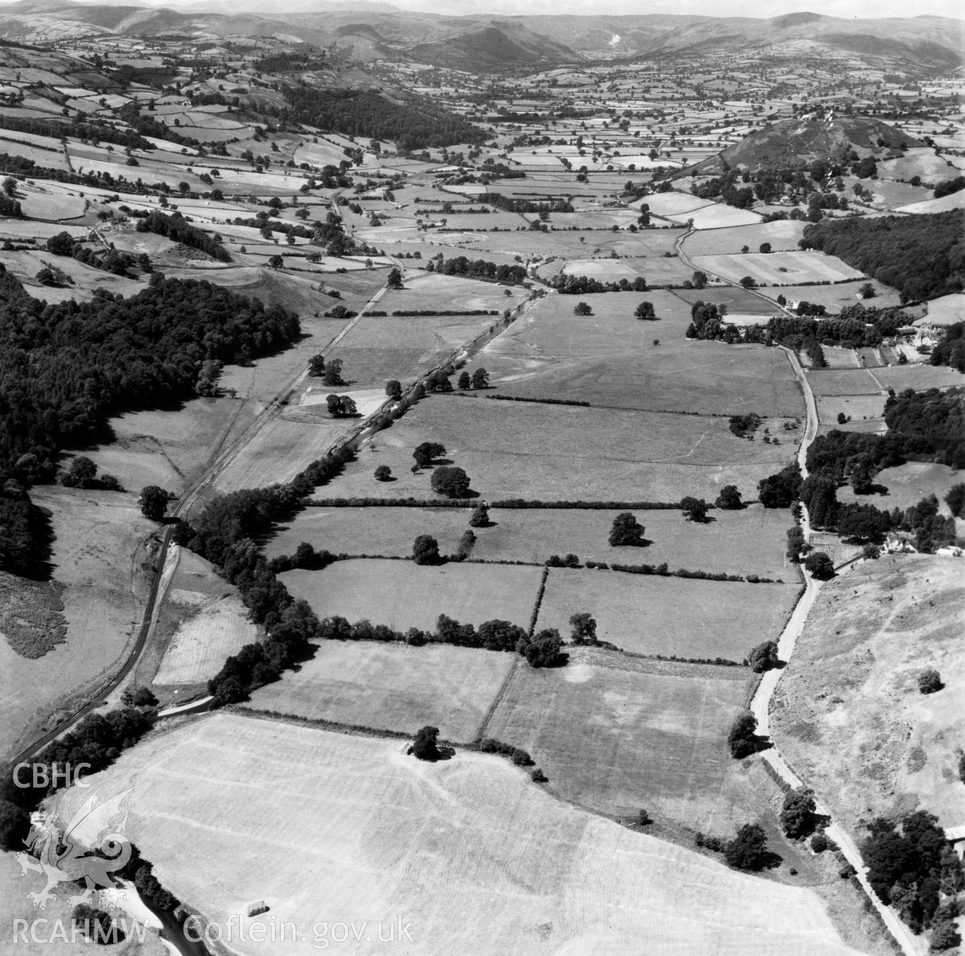 View of the Tanat valley looking west near Llangedwyn, showing railway. Oblique aerial photograph.