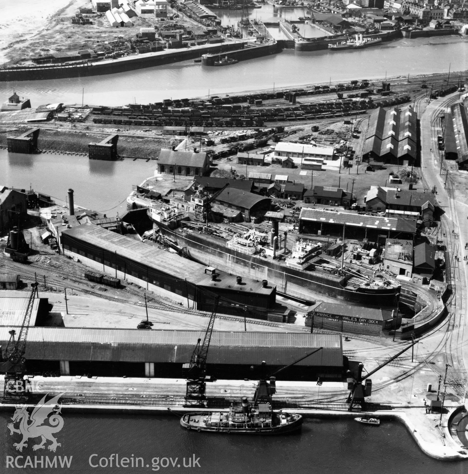 View of Prince of Wales dry dock, Swansea, showing the ship 'Pendeen' in dry dock. Oblique aerial photograph, 5?" cut roll film.