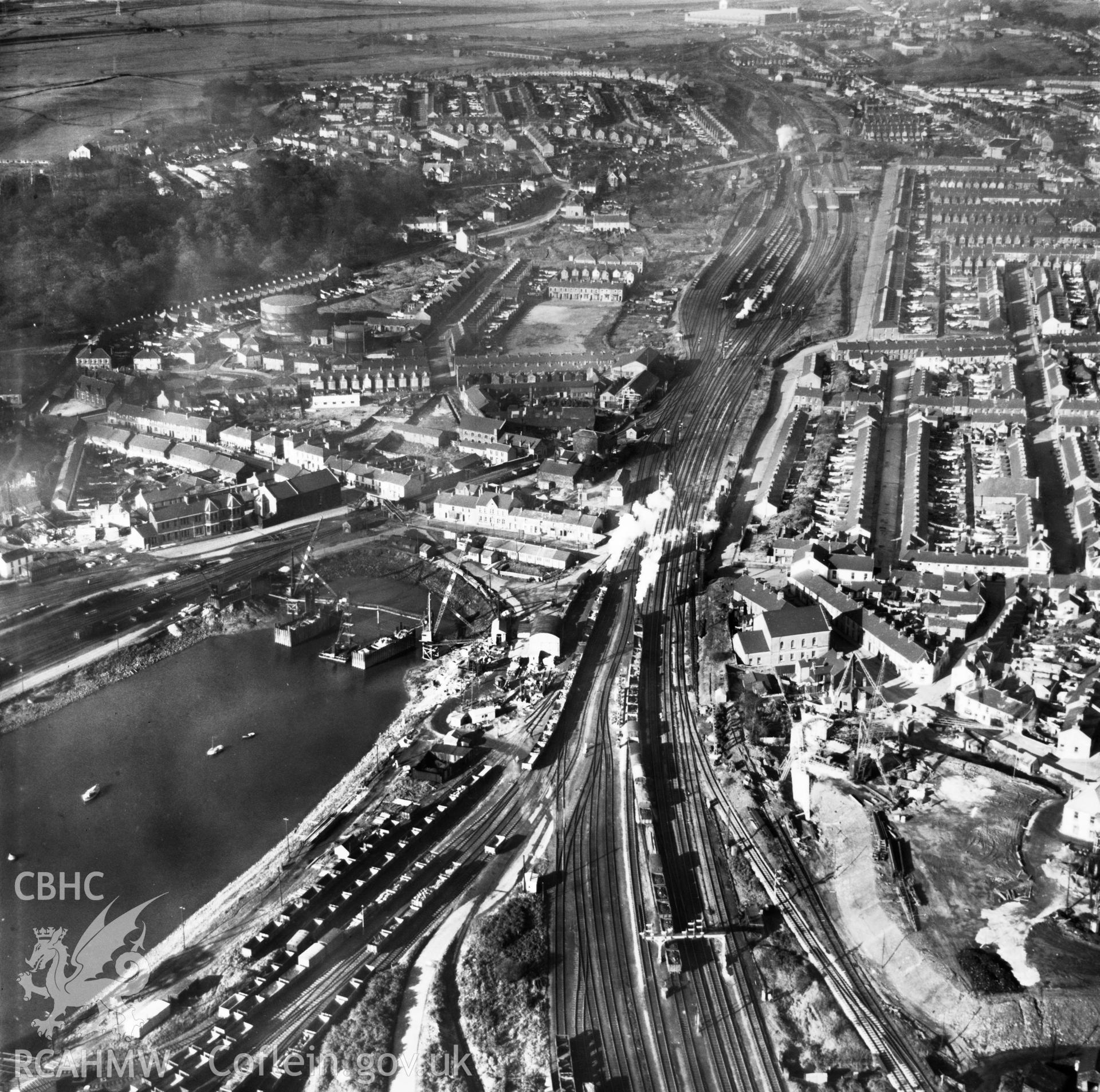 View of Briton Ferry and the Cleveland Bridge under construction. Oblique aerial photograph, 5?" cut roll film.