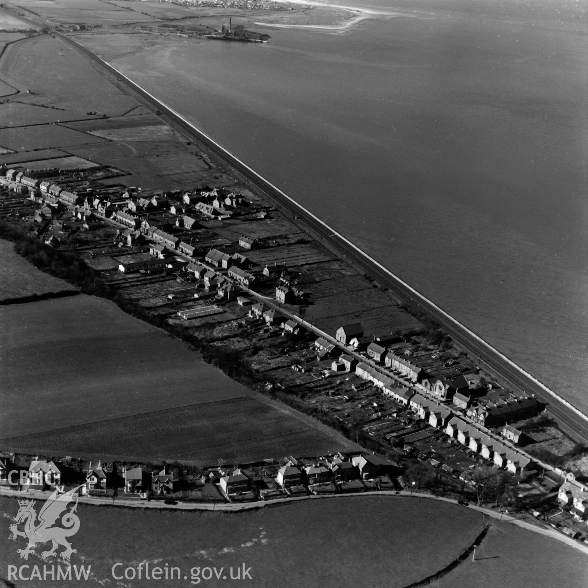 View of Ffynnongroyw with Point of Ayr colliery in the distance. Oblique aerial photograph, 5?" cut roll film.