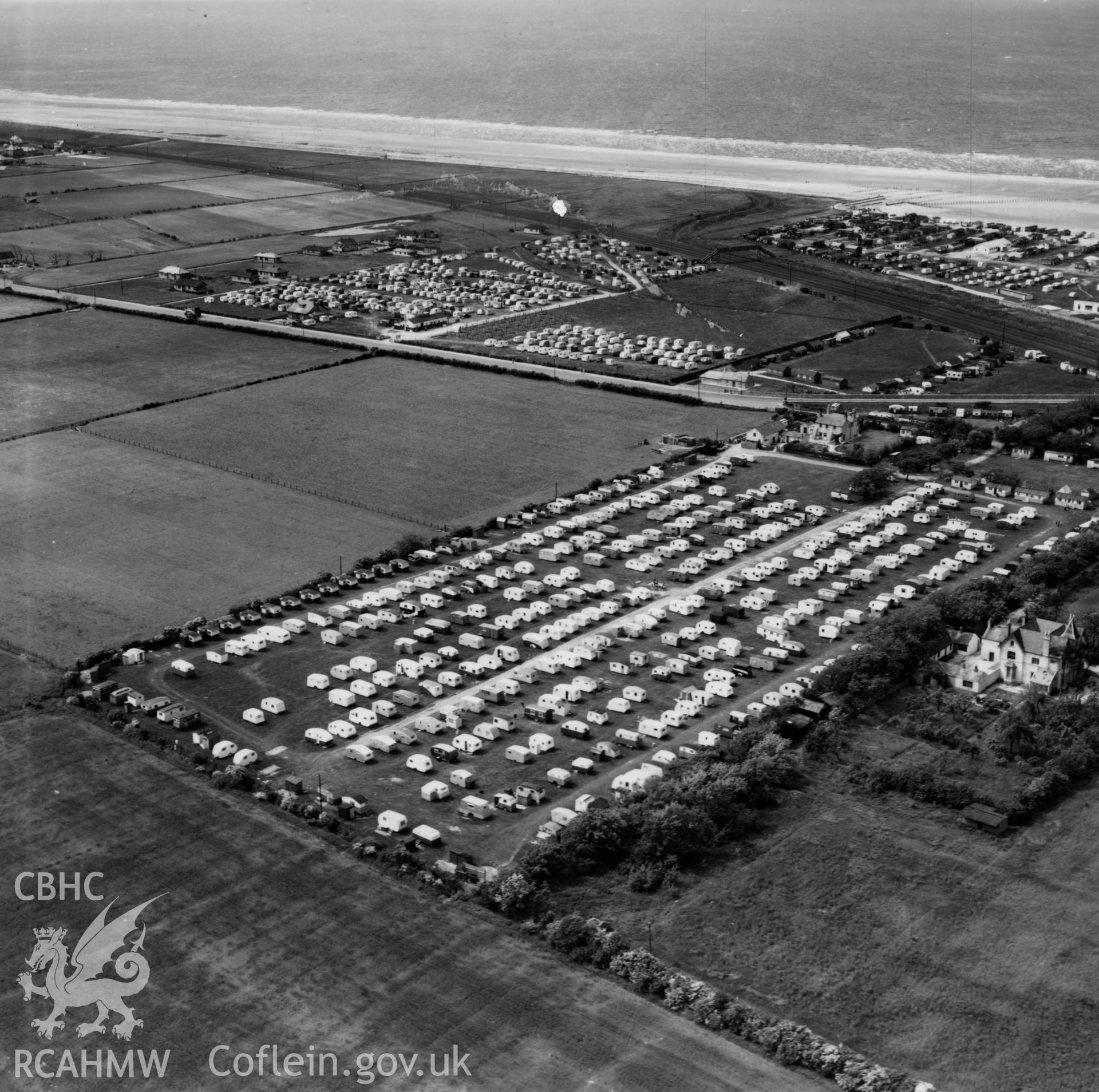 View of Palin's Holiday Camp, Foryd, commissioned by W.H.Smith & Son Ltd.. Oblique aerial photograph, 5?" cut roll film.