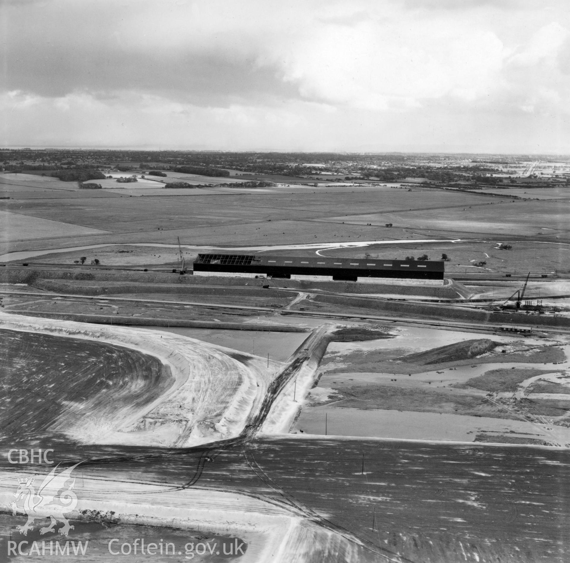 View of of Dee estuary during dreging work for Shotton Steelworks. Commissioned by the Westminster Dredging Co. Ltd.. Oblique aerial photograph, 5?" cut roll film.