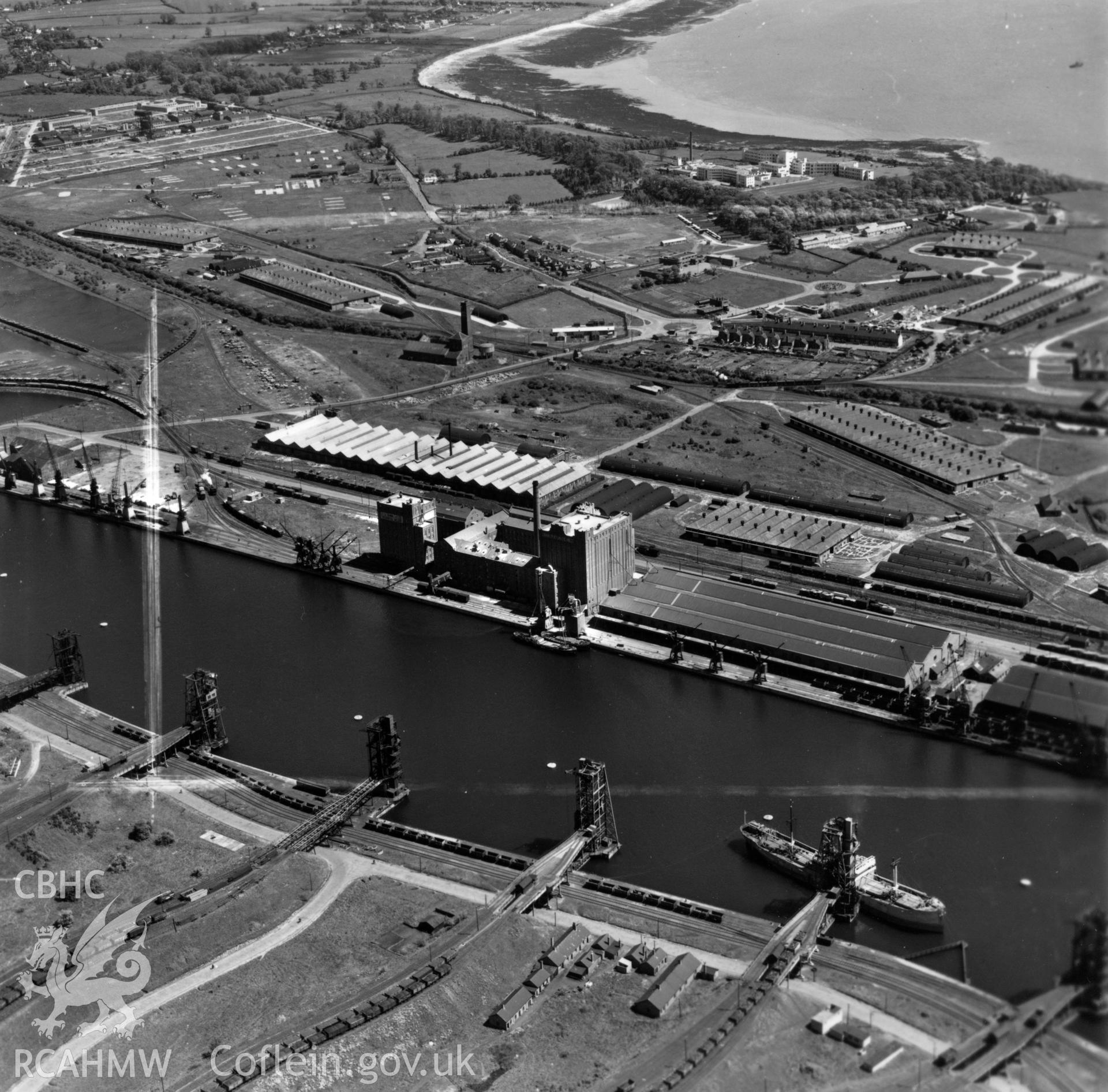 View of Rank Hovis Atlantic Mills at No. 2 Dock, Barry Docks, with distant view of Sully Hospital. Oblique aerial photograph, 5?" cut roll film.