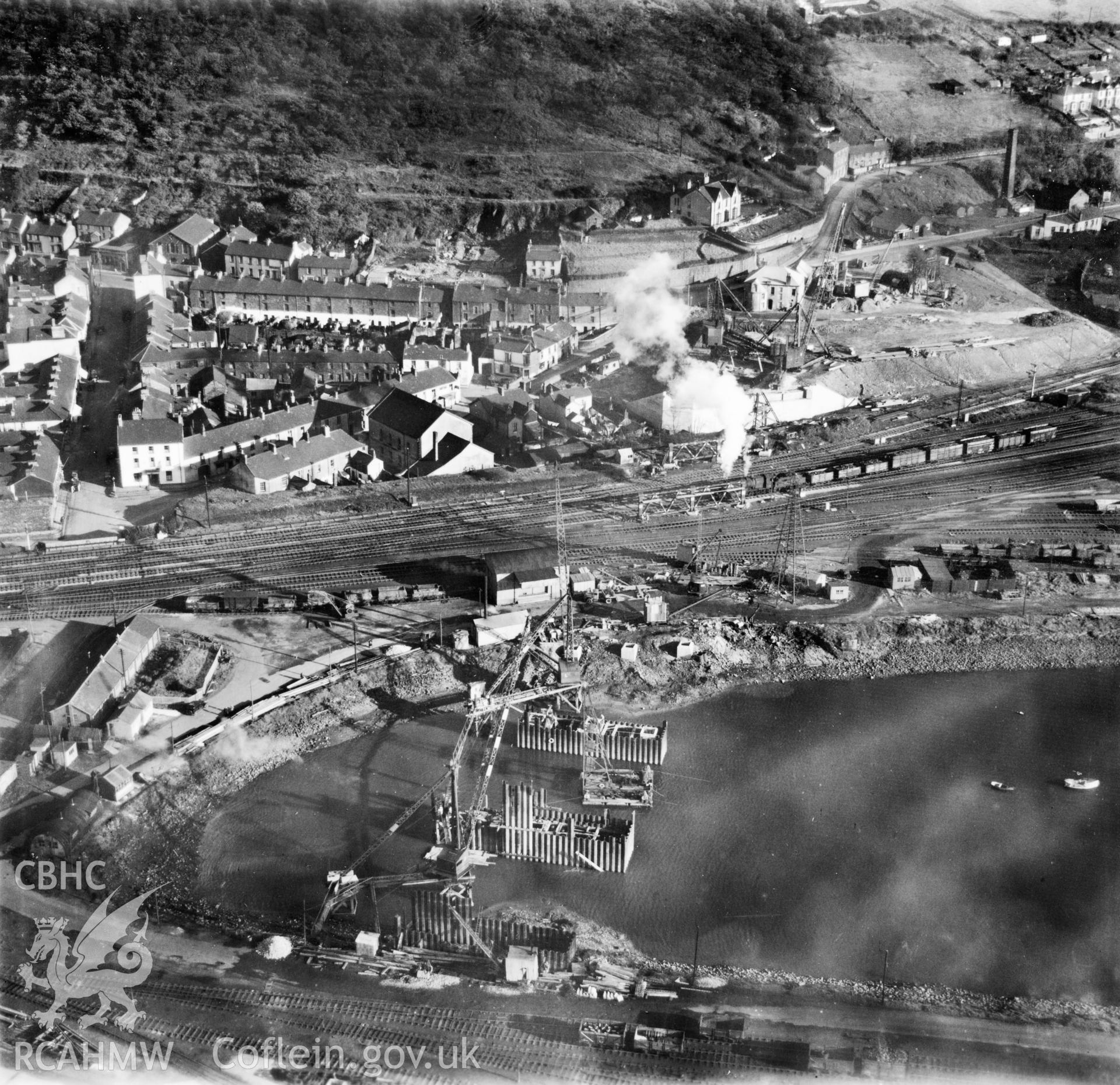 View of Briton Ferry and the Cleveland Bridge under construction. Oblique aerial photograph, 5?" cut roll film.