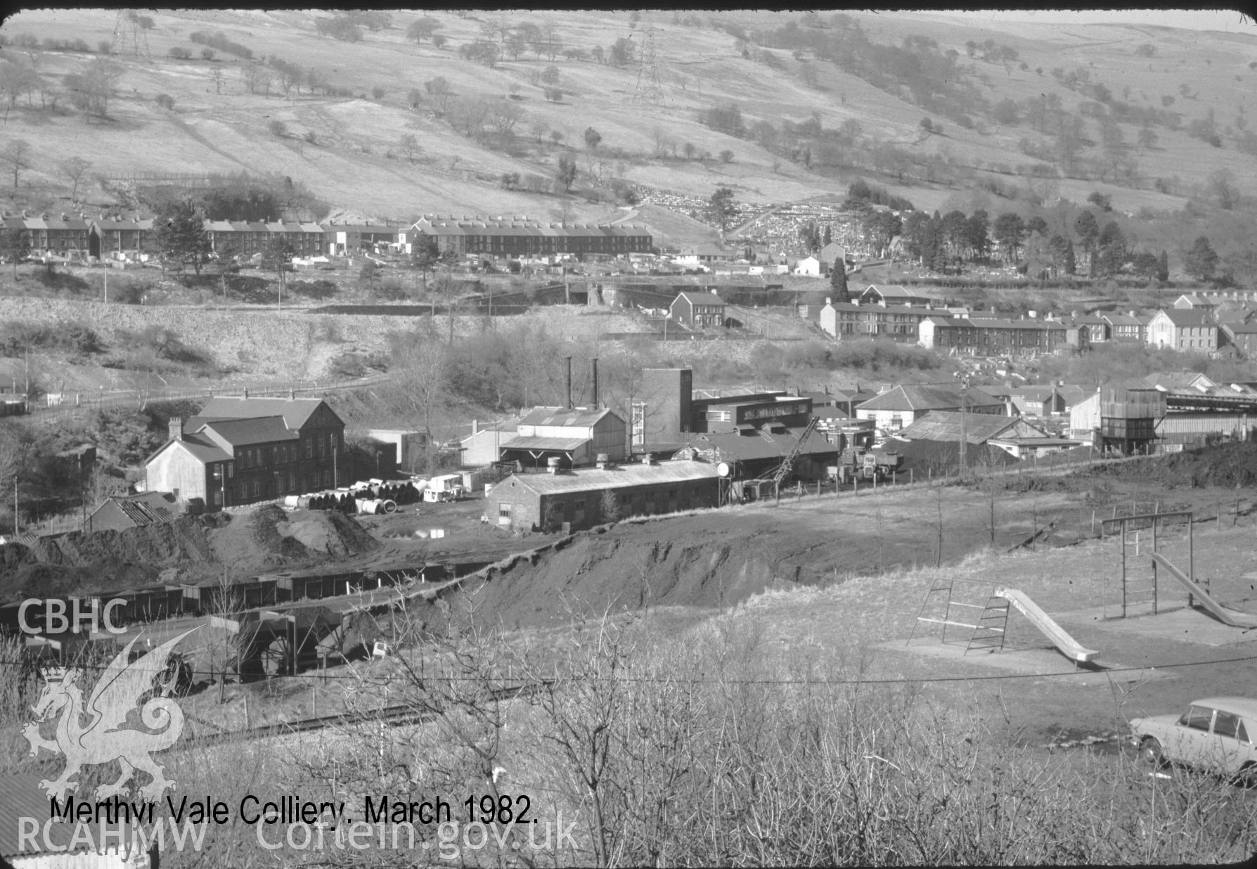 Digital photograph showing Merthyr Vale colliery with children's playground in the foreground, taken 1982.
