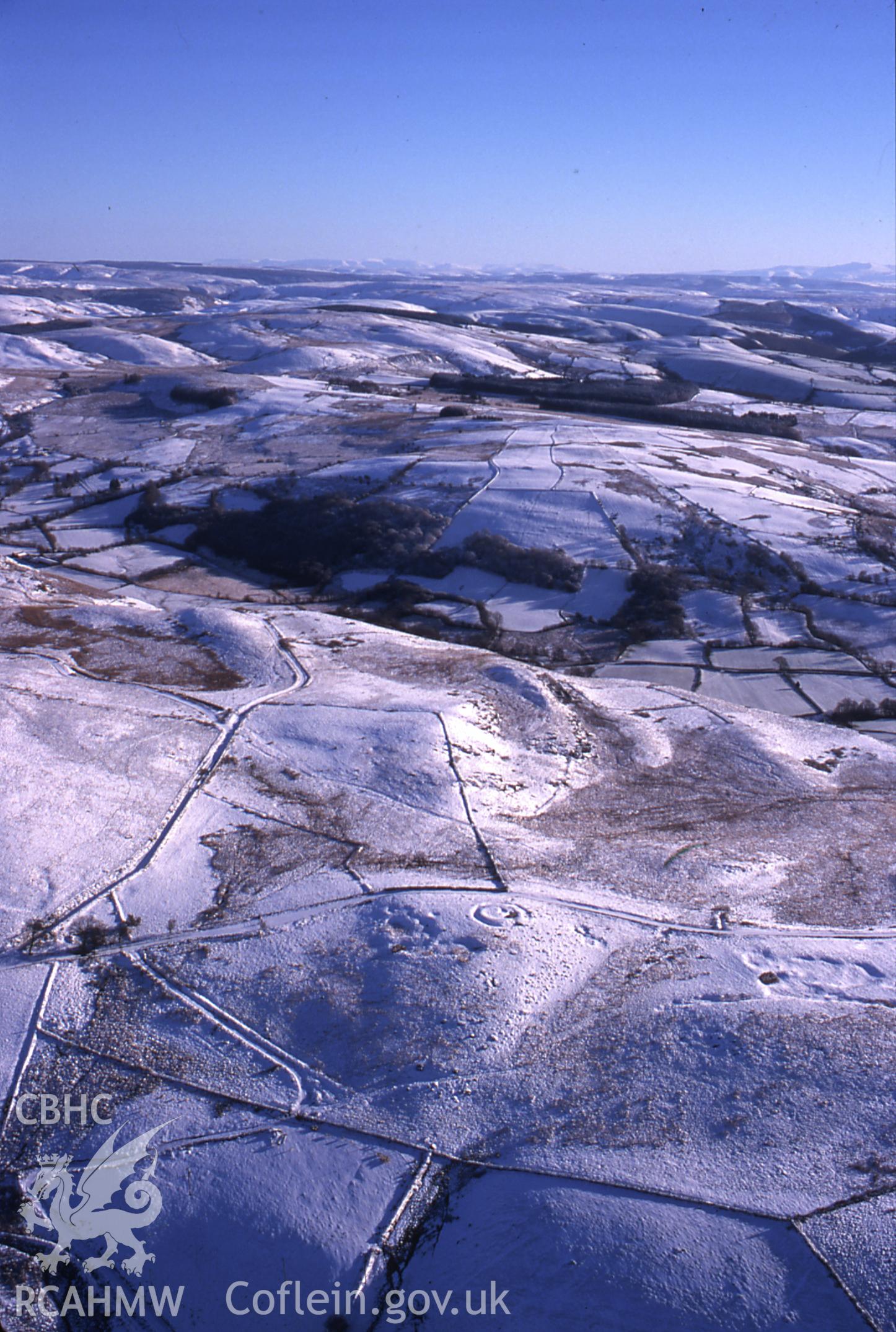 Slide of RCAHMW colour oblique aerial photograph of Carreg-y-bwci, taken by T.G. Driver, 19/12/1999.