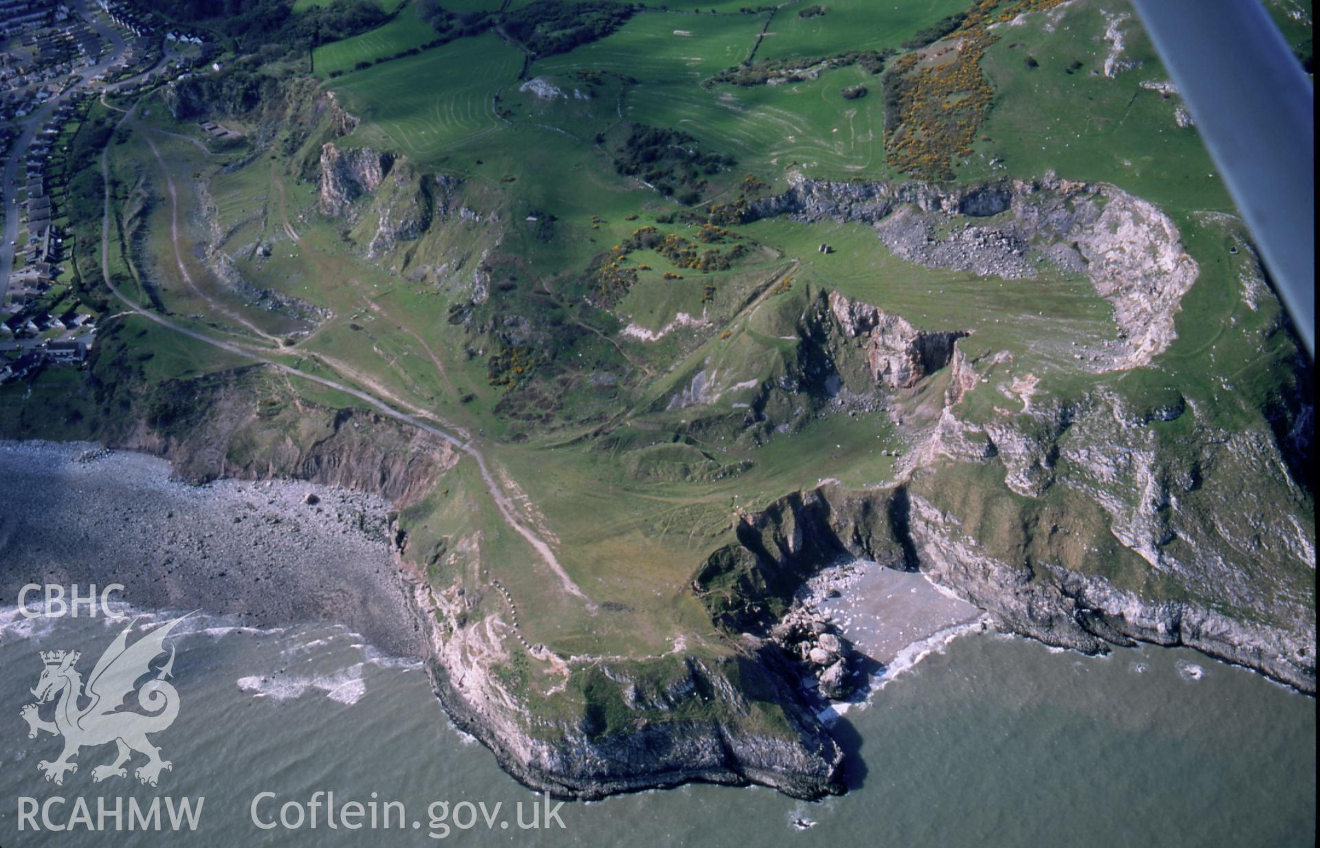 RCAHMW colour slide oblique aerial photograph of Ogof Rhiwleden, Llandudno, taken on 18/04/1998 by Toby Driver