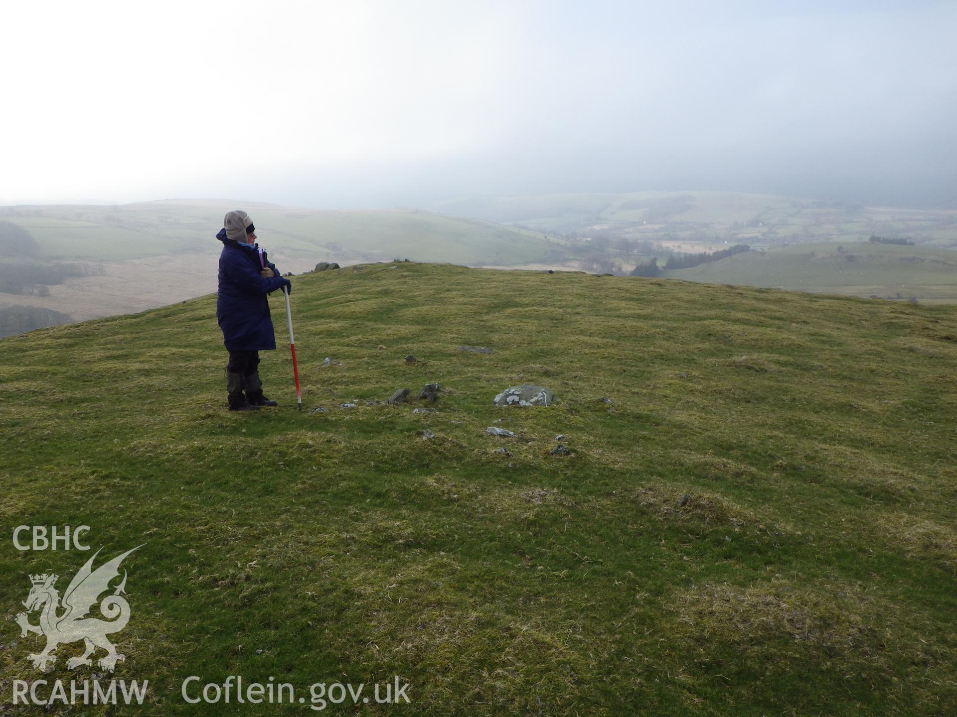 Grass-covered cairn, with cairn NPRN 303647 in the background, looking west northwest.