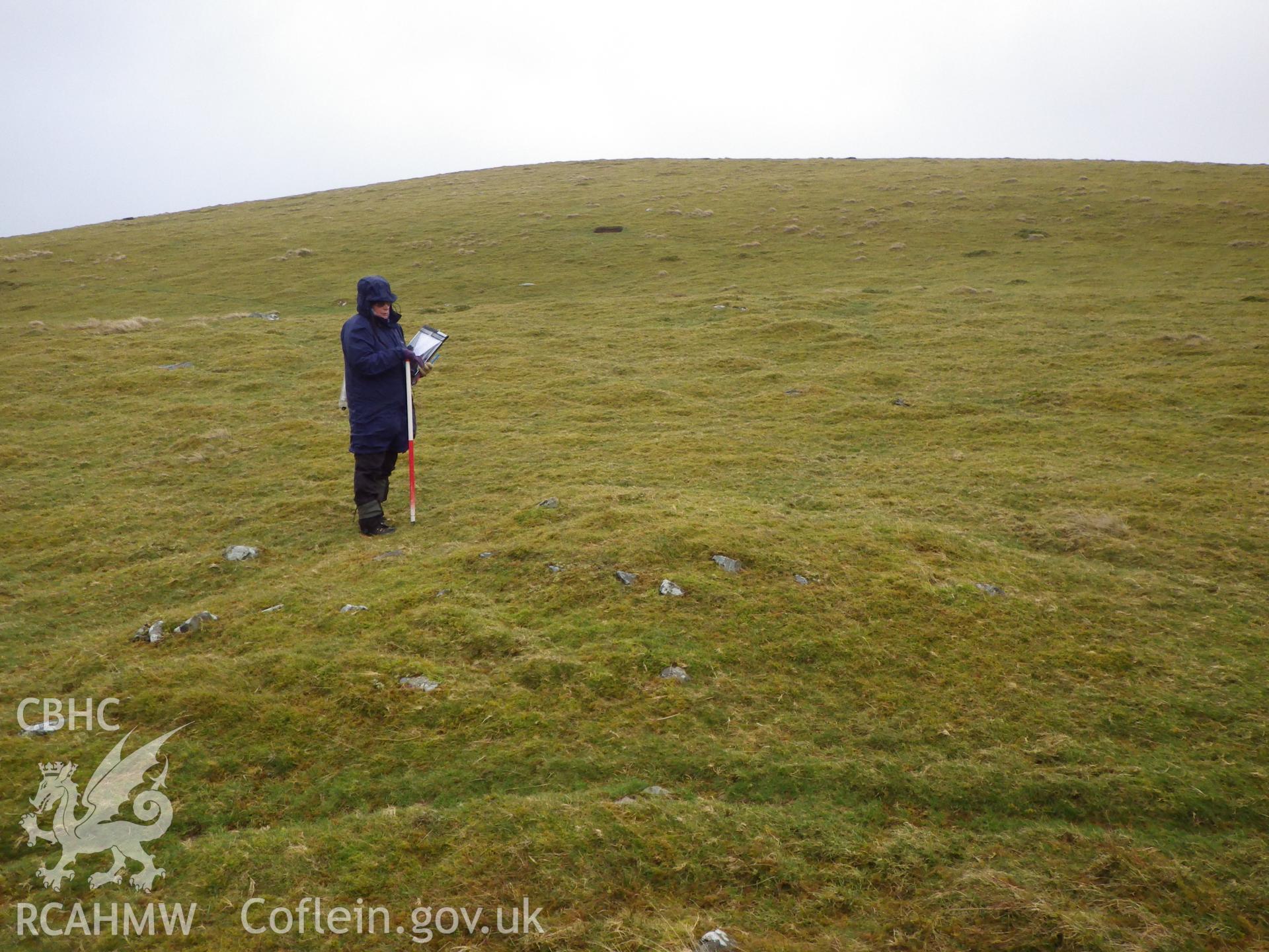 Low, grassed-over stone cairn, looking east northeast.