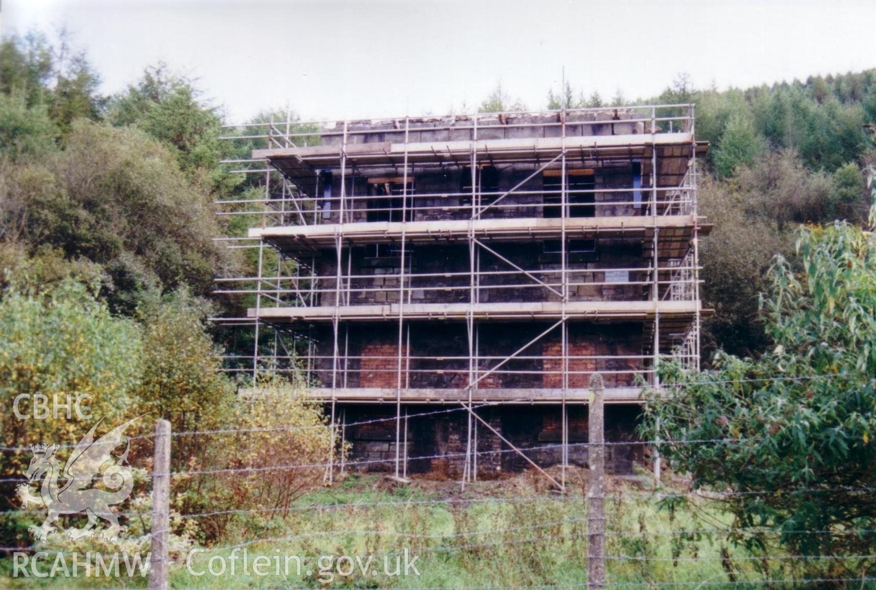 Vertical engine house, shrouded in scaffolding.